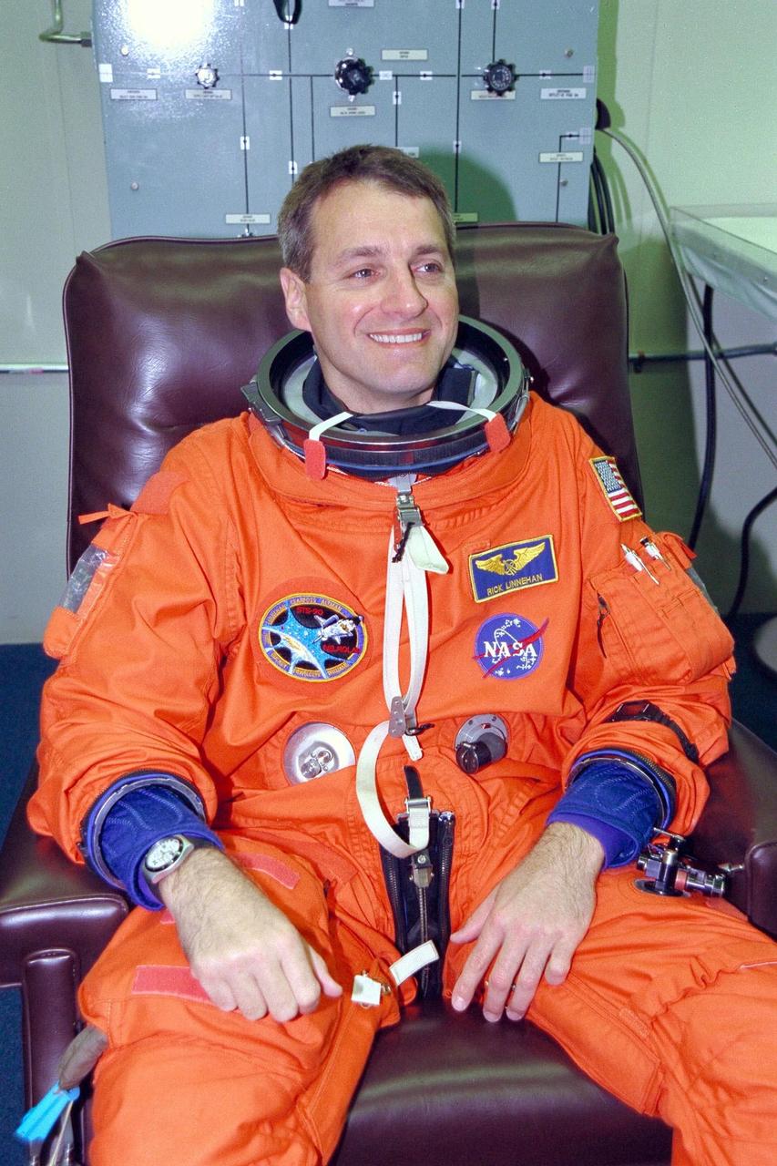 STS-90 Mission Specialist Richard Linnehan, D.V.M., sits in a chair during suitup activities in the Operations and Checkout Building. Linnehan and the rest of the STS-90 crew will shortly depart for Launch Pad 39B, where the Space Shuttle Columbia awaits a second liftoff attempt at 2:19 p.m. EDT. His second trip into space, Linnehan is participating in a life sciences research flight that will focus on the most complex and least understood part of the human body the nervous system. Neurolab will examine the effects of spaceflight on the brain, spinal cord, peripheral nerves and sensory organs in the human body