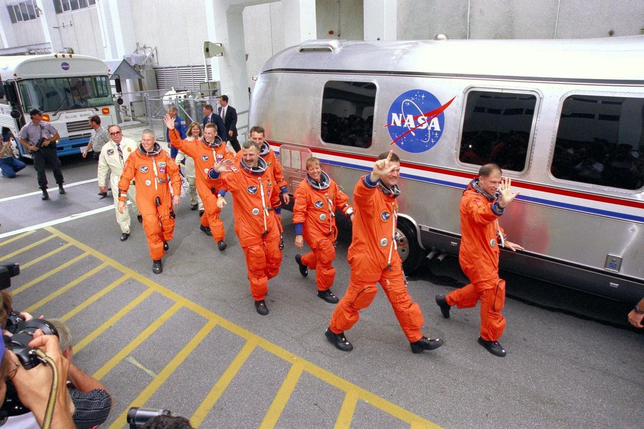 KENNEDY SPACE CENTER, FLA. -- Greeted by cheers from wellwishers at KSC and eager for their venture into space on the Neurolab mission, the STS-90 astronauts depart the Operations and Checkout Building on their way to Launch Pad 39B. The seven-member crew include (front to back, right to left) Mission Commander Richard Searfoss; Pilot Scott Altman; Mission Specialists Kathryn (Kay) Hire, Dafydd (Dave) Williams, M.D., with the Canadian Space Agency, and Richard Linnehan, D.V.M.; and Payload Specialists James Pawelczyk, Ph.D., and Jay Buckey, M.D. Their trip to the pad will take about 25 minutes aboard the Astrovan. Once there, they will take their positions in the crew cabin of the Space Shuttle Columbia to await a liftoff during a two-and-a-half hour window that will open at 2:19 p.m. EDT.