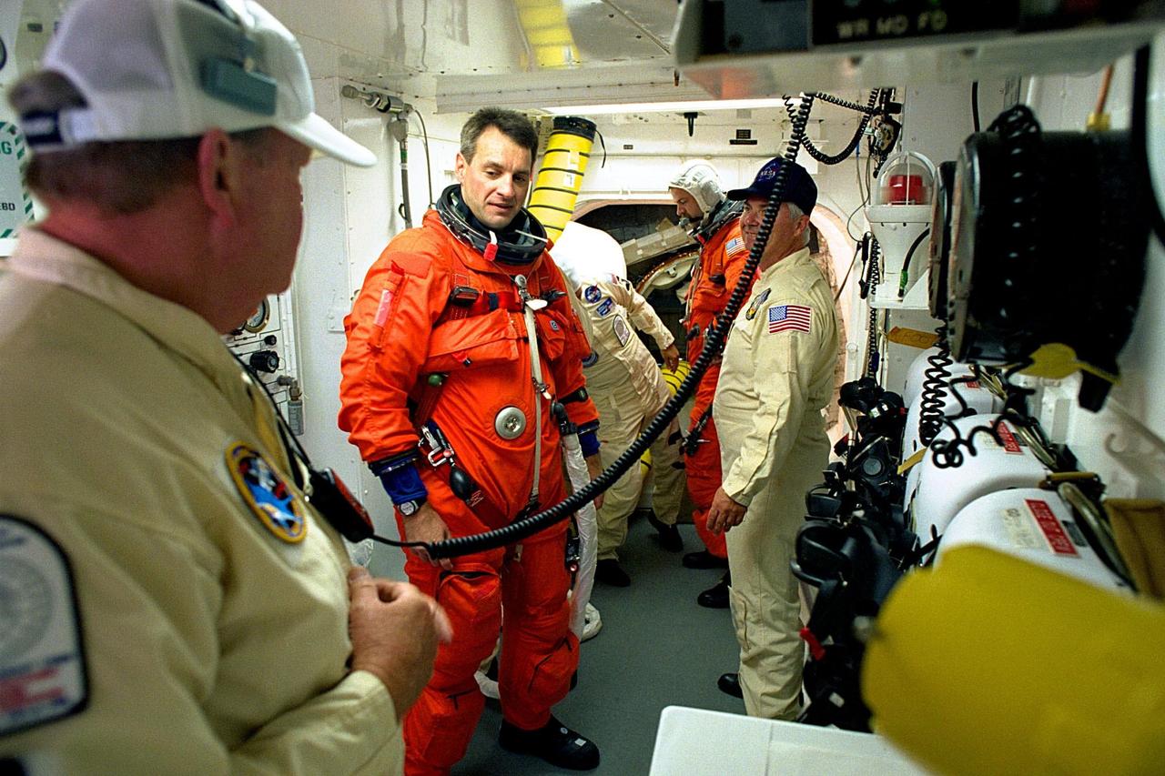 KENNEDY SPACE CENTER, FLA. -- STS-90 Mission Specialist Richard Linnehan, D.V.M., is assisted by NASA and United Space Alliance closeout crew members immediately preceding launch for the nearly 17-day Neurolab mission. Investigations during the Neurolab mission will focus on the effects of microgravity on the nervous system. Linnehan and six fellow crew members will shortly enter the orbiter at KSC's Launch Pad 39B, where the Space Shuttle Columbia will lift off during a launch window that opens at 2:19 p.m. EDT, April 17