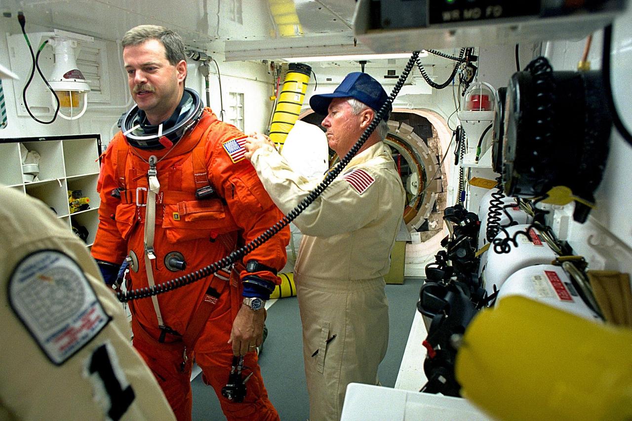 KENNEDY SPACE CENTER, FLA. -- STS-90 Pilot Scott Altman is assisted by NASA and United Space Alliance closeout crew members immediately preceding launch for the nearly 17-day Neurolab mission. Investigations during the Neurolab mission will focus on the effects of microgravity on the nervous system. Altman and six fellow crew members will shortly enter the orbiter at KSC's Launch Pad 39B, where the Space Shuttle Columbia will lift off during a launch window that opens at 2:19 p.m. EDT, April 17