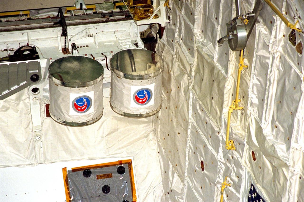 Processing activities for STS-91 continue in KSC's Orbiter Processing Facility Bay 2. Two Get Away Special (GAS) canisters are shown after their installation into Discovery's payload bay. At left is G-090, containing three educational experiments sponsored by Utah State University, and at right is G-743, an experiment sponsored by Broward Community College in Florida to test DNA exposed to cosmic radiation in a microgravity environment. STS-91 is scheduled to launch aboard the Space Shuttle Discovery for the ninth and final docking with the Russian Space Station Mir from KSC's Launch Pad 39A on June 2 with a launch window opening around 6:04 p.m. EDT
