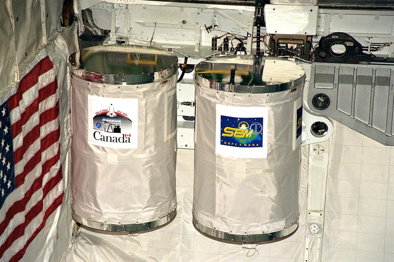 Processing activities for STS-91 continue in Orbiter Processing Facility Bay 2. Two Get Away Special (GAS) canisters are shown after their installation into Discovery's payload bay. The GAS payload G-765, in the canister on the left, is sponsored by the Canadian Space Agency and managed by C-CORE/Memorial University of Newfoundland. It is a study to understand the transport of fluids in porous media as it pertains to improving methods for enhanced oil recovery. The GAS canister on the right houses the Space Experiment Module (SEM-05), part of an educational initiative of NASA's Shuttle Small Payloads Project. STS-91 is scheduled to launch aboard the Space Shuttle Discovery for the ninth and final docking with the Russian Space Station Mir from KSC's Launch Pad 39A on June 2 with a launch window opening around 6:04 p.m. EDT