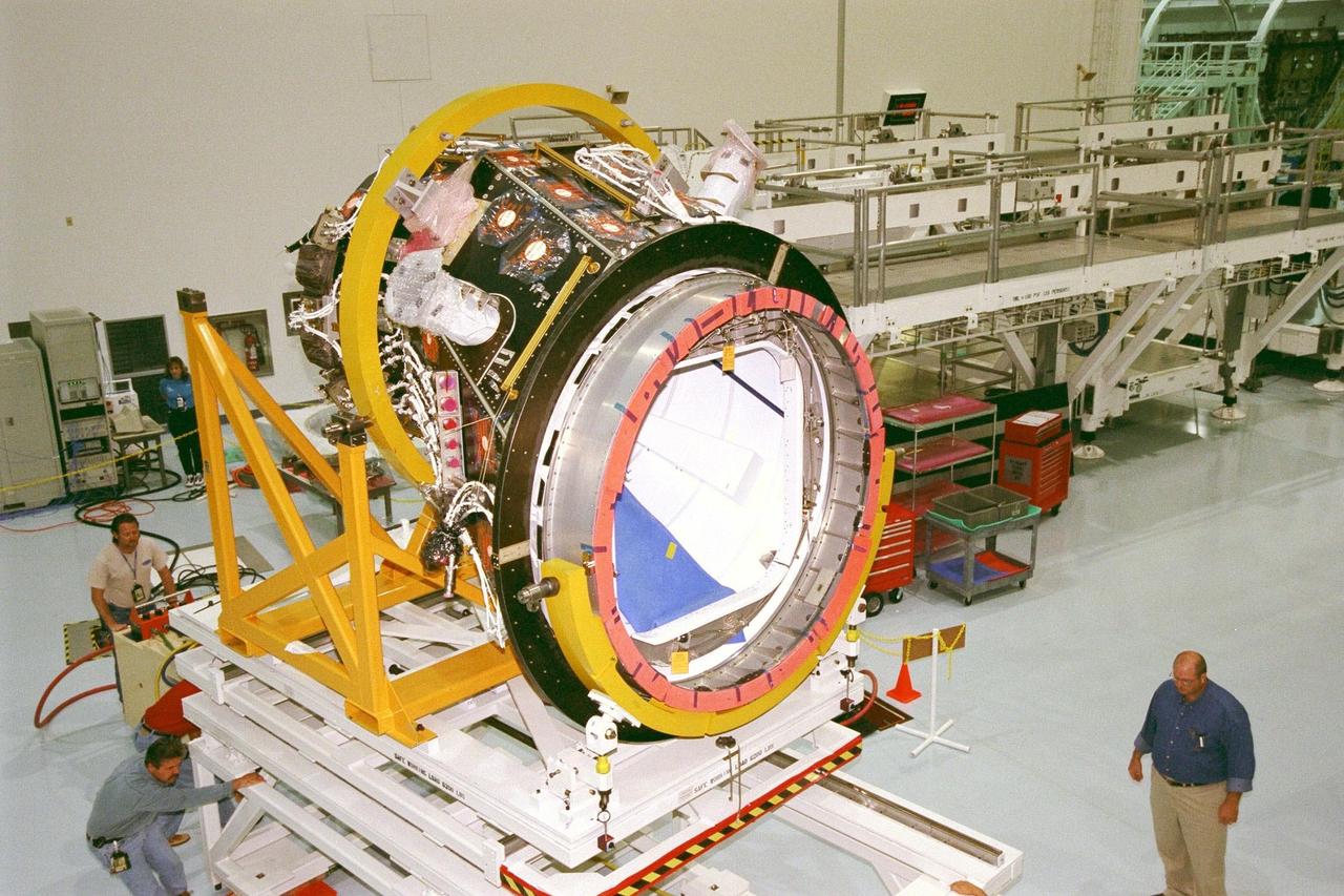 KENNEDY SPACE CENTER, FLA. -- Pressurized Mating Adapter (PMA)-2 is moved toward Node 1 of the International Space Station (ISS) in KSC's Space Station Processing Facility for pre-mating preparations. The node is the first element of the ISS to be manufactured in the United States and is currently scheduled to lift off aboard the Space Shuttle Endeavour on STS-88 later this year, along with PMAs 1 and 2. This PMA is a cone-shaped connector to Node 1, which will have two PMAs attached once this mate is completed. Once in space, Node 1 will function as a connecting passageway to the living and working areas of the ISS. It has six hatches that will serve as docking ports to the U.S. laboratory module, U.S. habitation module, an airlock and other space station elements