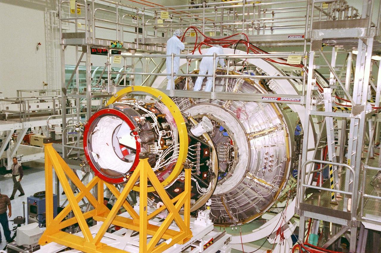 KENNEDY SPACE CENTER, FLA. -- Pressurized Mating Adapter (PMA)-2 is moved into position against Node 1 of the International Space Station (ISS) in KSC's Space Station Processing Facility for pre-mating preparations. The node is the first element of the ISS to be manufactured in the United States and is currently scheduled to lift off aboard the Space Shuttle Endeavour on STS-88 later this year, along with PMAs 1 and 2. This PMA is a cone-shaped connector to Node 1, which will have two PMAs attached once this mate is completed. Once in space, Node 1 will function as a connecting passageway to the living and working areas of the ISS. It has six hatches that will serve as docking ports to the U.S. laboratory module, U.S. habitation module, an airlock and other space station elements
