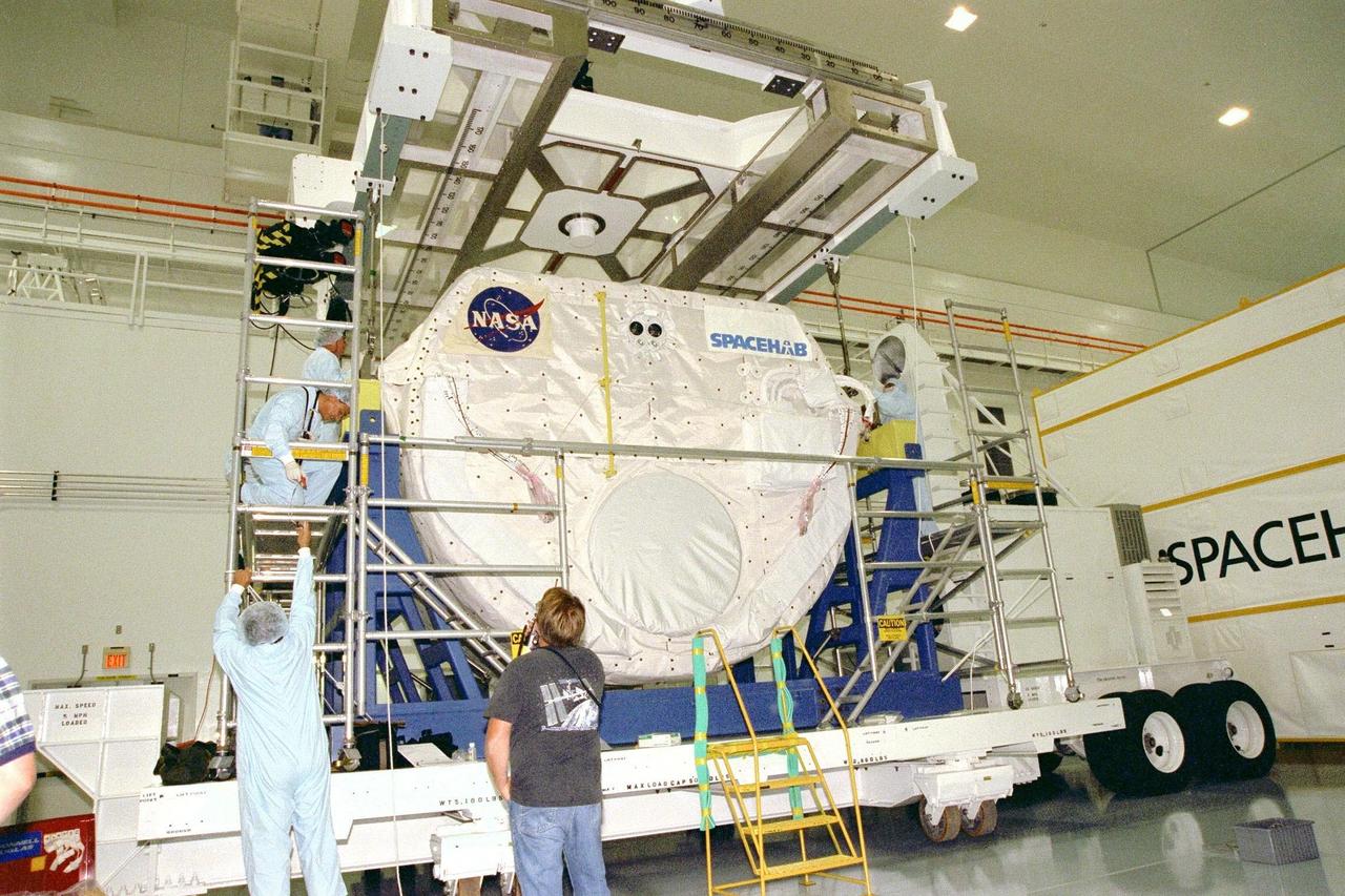 The SPACEHAB Single Module is raised by crane from a transporter in KSC's Space Station Processing Facility, where it will be moved to the payload canister. It will be joined in the canister by the Alpha Magnetic Spectrometer-01 payload before being moved to Launch Pad 39A for the STS-91 mission, scheduled to launch June 2 at around 6:04 p.m. EDT. SPACEHAB is used mainly as a large pressurized cargo container for science, logistical equipment and supplies to be exchanged between the orbiter Discovery and the Russian Space Station Mir. The nearly 10-day flight of STS-91 also is scheduled to return the sixth American, Mission Specialist Andrew Thomas, Ph.D., aboard the Russian orbiting outpost safely to Earth