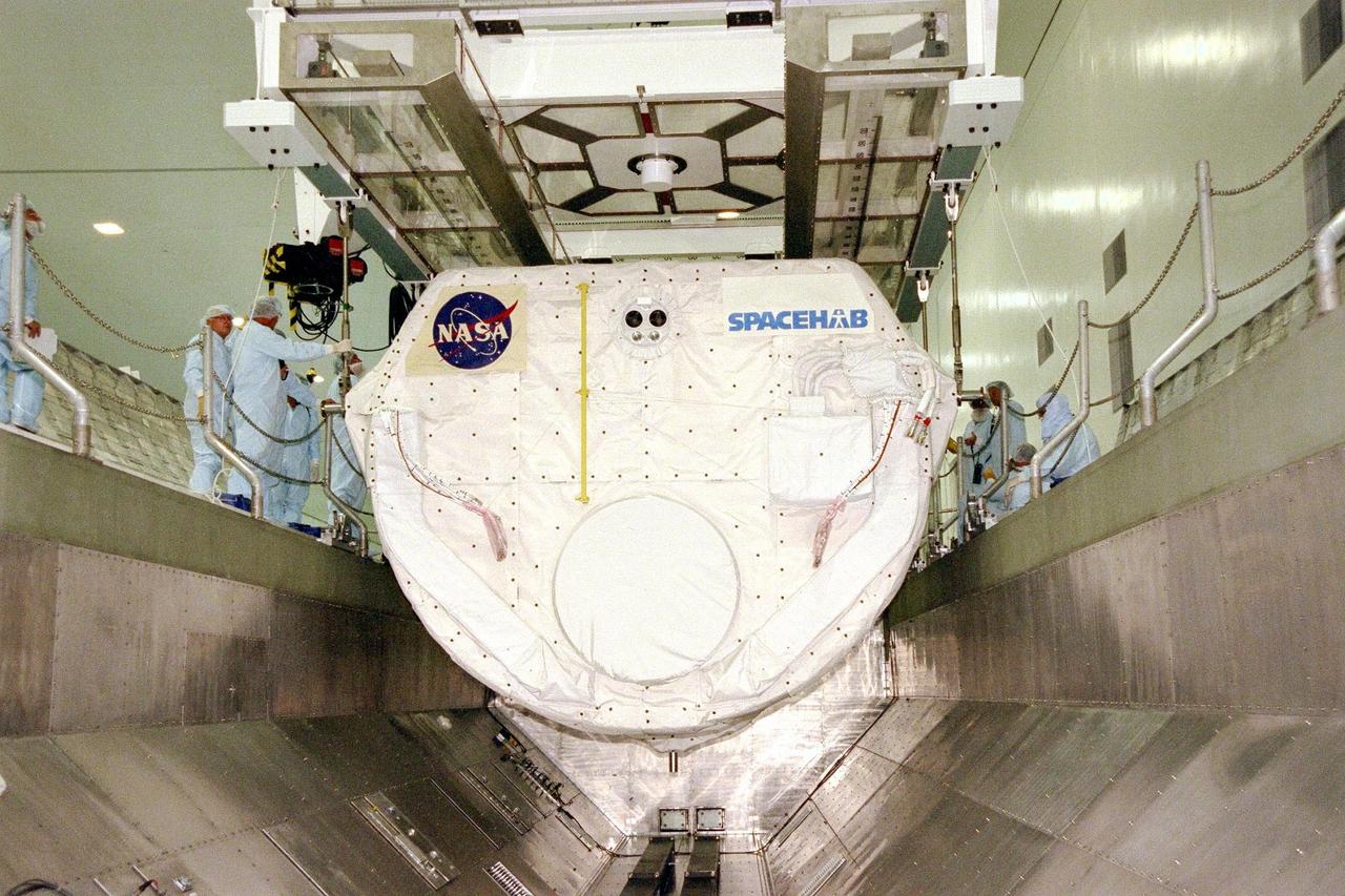 KENNEDY SPACE CENTER, FLA. -- The SPACEHAB Single Module is lowered into the payload canister in KSC's Space Station Processing Facility. It will be joined in the canister by the Alpha Magnetic Spectrometer-01 payload before being moved to Launch Pad 39A for the STS-91 mission, scheduled to launch June 2 at around 6:04 p.m. EDT. SPACEHAB is used mainly as a large pressurized cargo container for science, logistical equipment and supplies to be exchanged between the orbiter Discovery and the Russian Space Station Mir. The nearly 10-day flight of STS-91 also is scheduled to return the sixth American, Mission Specialist Andrew Thomas, Ph.D., aboard the Russian orbiting outpost safely to Earth