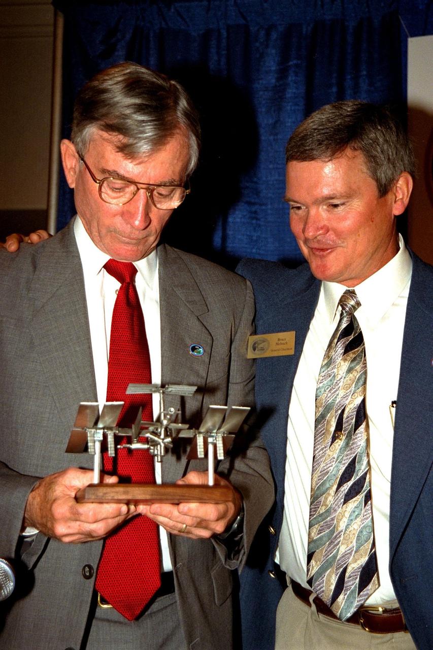 Astronaut John Young (left), the keynote speaker at the Thirty-Fifth Space Congress, is presented with a model of the International Space Station by the Congress' General Chairman Bruce Melnick. Young is the associate director responsible for technical, operational and safety oversight of all NASA programs and activities assigned to the Johnson Space Center. Melnick, a former astronaut, is currently vice president of The Boeing Company and is responsible for the Payload Ground Operations Contract at Kennedy Space Center. The Thirty-Fifth Space Congress, sponsored by the Canaveral Council of Technical Societies, is being held in Cocoa Beach, Florida, from April 28 to May 1 and is a gathering of the world's aerospace community to discuss the status and future of space activities around the world