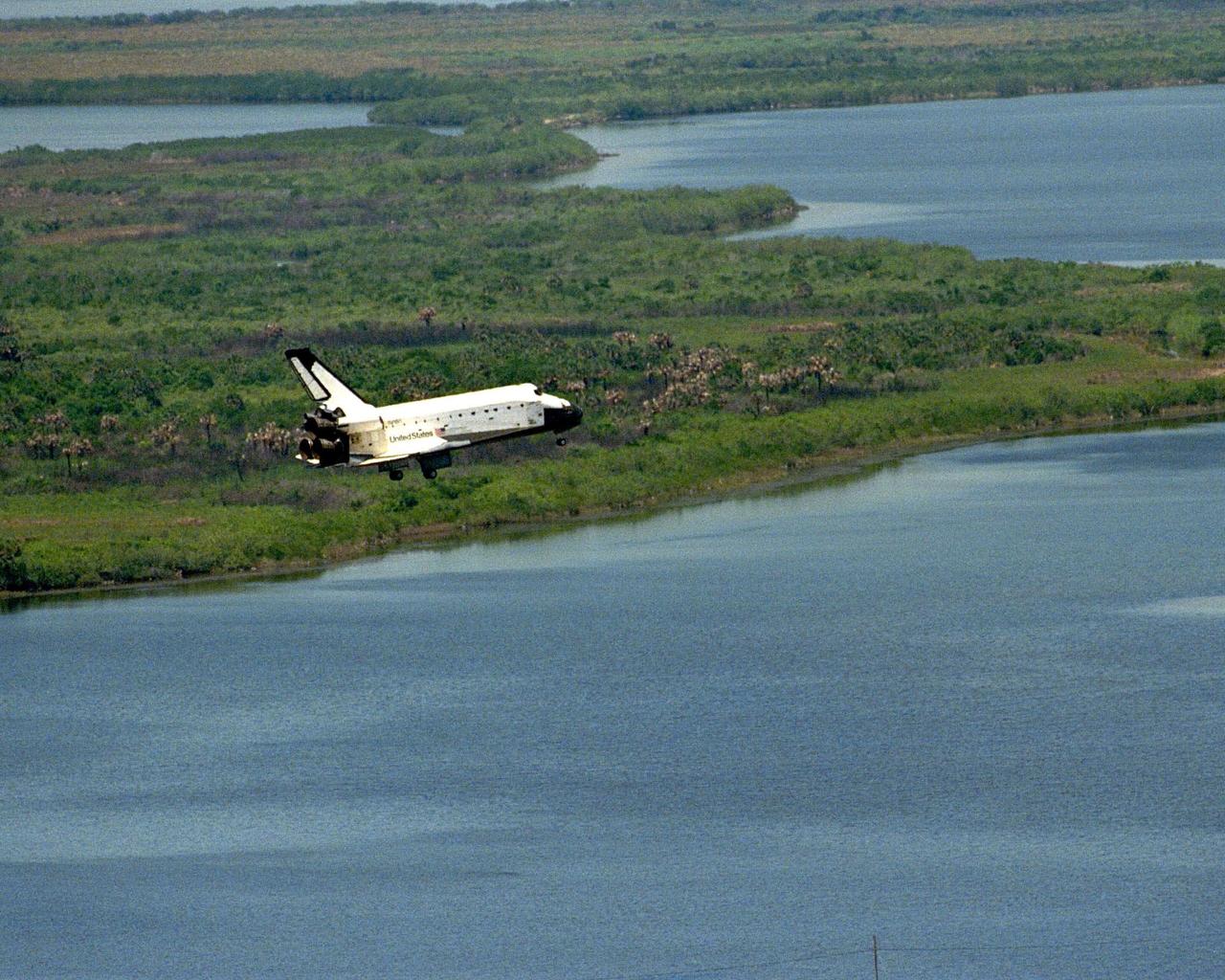The orbiter Columbia approaches touchdown on Runway 33 of KSC's Shuttle Landing Facility to complete the nearly 16-day STS-90 mission. Framed by Florida foliage and wetlands, this unique view was taken from the roof of the 525-foot-high Vehicle Assembly Building. Main gear touchdown was at 12:08:59 p.m. EDT on May 3, 1998, landing on orbit 256 of the mission. The wheels stopped at 12:09:58 EDT, completing a total mission time of 15 days, 21 hours, 50 minutes and 58 seconds. The 90th Shuttle mission was Columbia's 13th landing at the space center and the 43rd KSC landing in the history of the Space Shuttle program. During the mission, the crew conducted research to contribute to a better understanding of the human nervous system. The crew of the STS-90 Neurolab mission include Commander Richard Searfoss; Pilot Scott Altman; Mission Specialists Richard Linnehan, D.V.M., Dafydd (Dave) Williams, M.D., with the Canadian Space Agency, and Kathryn (Kay) Hire; and Payload Specialists Jay Buckey, M.D., and James Pawelczyk, Ph.D