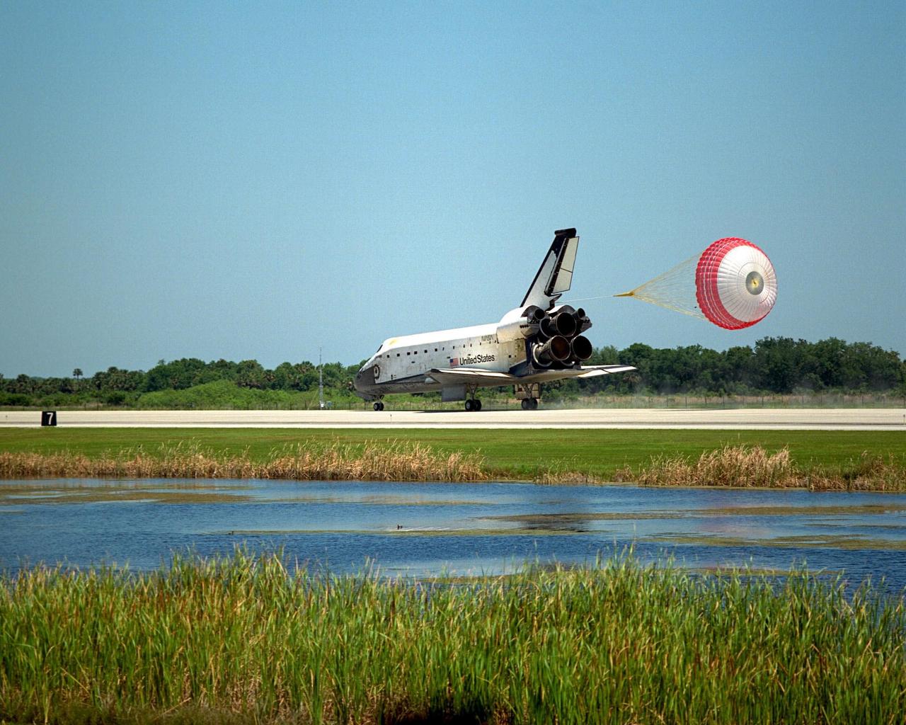 With its drag chute deployed, the orbiter Columbia touches down on Runway 33 of KSC's Shuttle Landing Facility to complete the nearly 16-day STS-90 mission. Main gear touchdown was at 12:08:59 p.m. EDT on May 3, 1998, landing on orbit 256 of the mission. The wheels stopped at 12:09:58 EDT, completing a total mission time of 15 days, 21 hours, 50 minutes and 58 seconds. The 90th Shuttle mission was Columbia's 13th landing at the space center and the 43rd KSC landing in the history of the Space Shuttle program. During the mission, the crew conducted research to contribute to a better understanding of the human nervous system. The crew of the STS-90 Neurolab mission include Commander Richard Searfoss; Pilot Scott Altman; Mission Specialists Richard Linnehan, D.V.M., Dafydd (Dave) Williams, M.D., with the Canadian Space Agency, and Kathryn (Kay) Hire; and Payload Specialists Jay Buckey, M.D., and James Pawelczyk, Ph.D