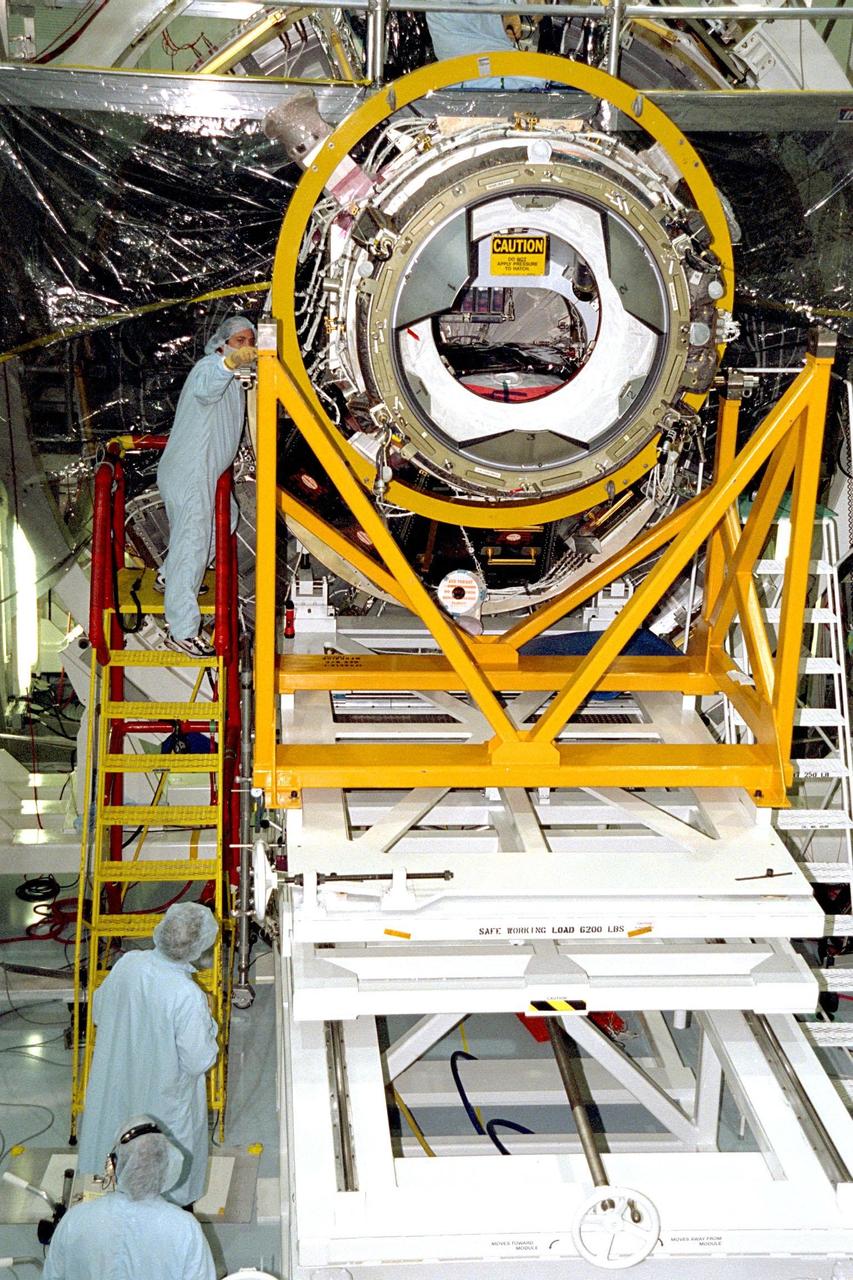 Pressurized Mating Adapter (PMA)-2 is moved into position to be mated to Node 1 of the International Space Station (ISS) by Boeing technicians in KSC's Space Station Processing Facility (SSPF). The node is the first element of the ISS to be manufactured in the United States and is currently scheduled to lift off aboard the Space Shuttle Endeavour on STS-88 later this year, along with PMAs 1 and 2. This PMA is a cone-shaped connector to Node 1, which will have two PMAs attached once this mate is completed. Once in space, Node 1 will function as a connecting passageway to the living and working areas of the ISS. It has six hatches that will serve as docking ports to the U.S. laboratory module, U.S. habitation module, an airlock and other space station elements