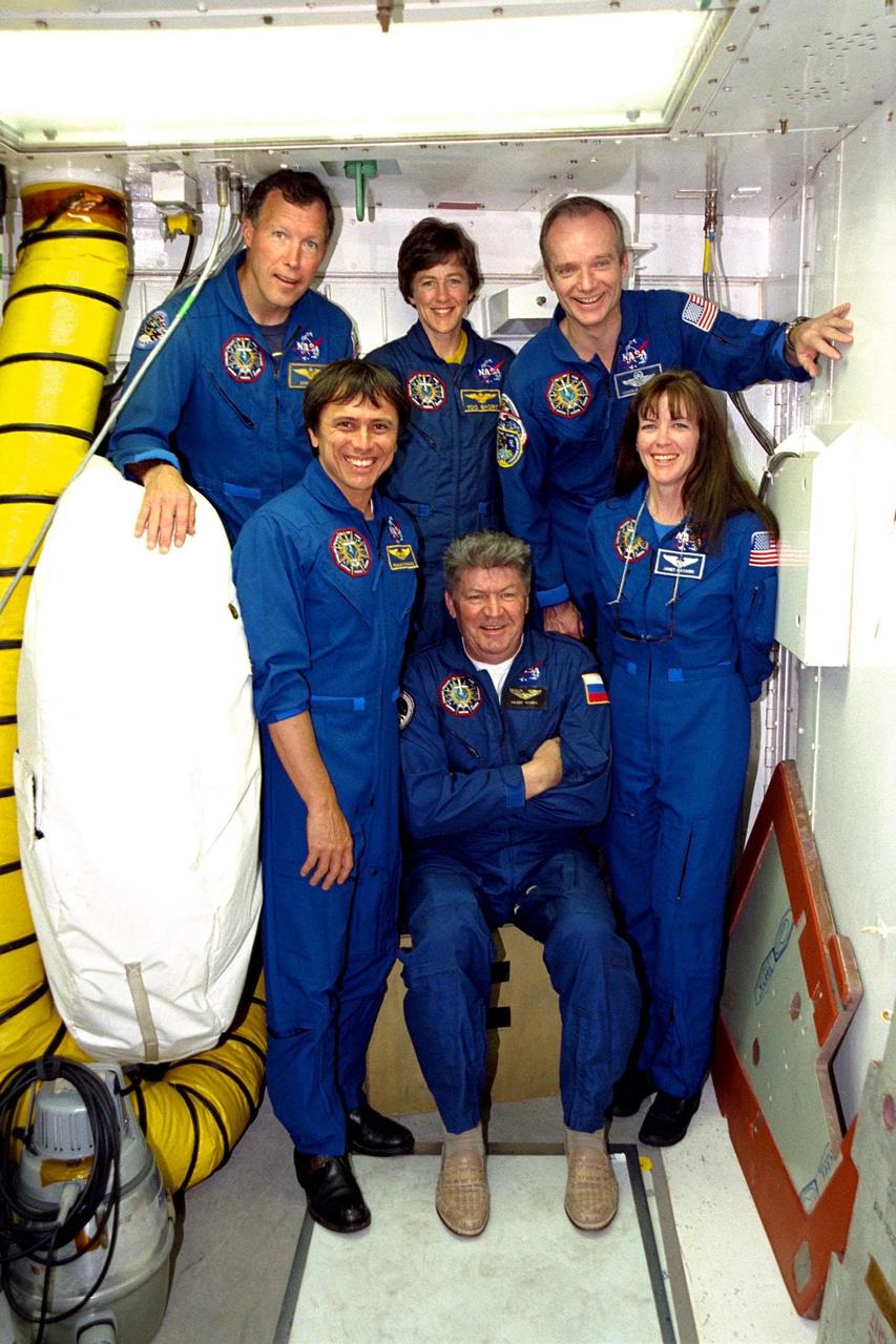 The STS-91 flight crew poses for a group portrait in the white room on the Orbiter Access Arm at Launch Complex 39A during Terminal Countdown Demonstration Test (TCDT) activities. The TCDT is held at KSC prior to each Space Shuttle flight to provide crews with an opportunity to participate in simulated countdown activities. From left to right, they are (back row) Pilot Dominic Gorie; Mission Specialist Wendy B. Lawrence and Mission Commander Charles Precourt; and (front row) Mission Specialists Franklin Chang-Diaz, Ph.D.; Valery Ryumin, with the Russian Space Agency; and Janet Kavandi, Ph.D. STS-91 is scheduled to be launched on June 2 with a launch window opening around 6:10 p.m. EDT. The mission will feature the ninth Shuttle docking with the Russian Space Station Mir, the first Mir docking for Discovery, the conclusion of Phase I of the joint U.S.-Russian International Space Station Program, and the first flight of the new Space Shuttle super lightweight external tank. Andrew Thomas, Ph.D., will be returning to Earth with the crew after living more than four months aboard Mir