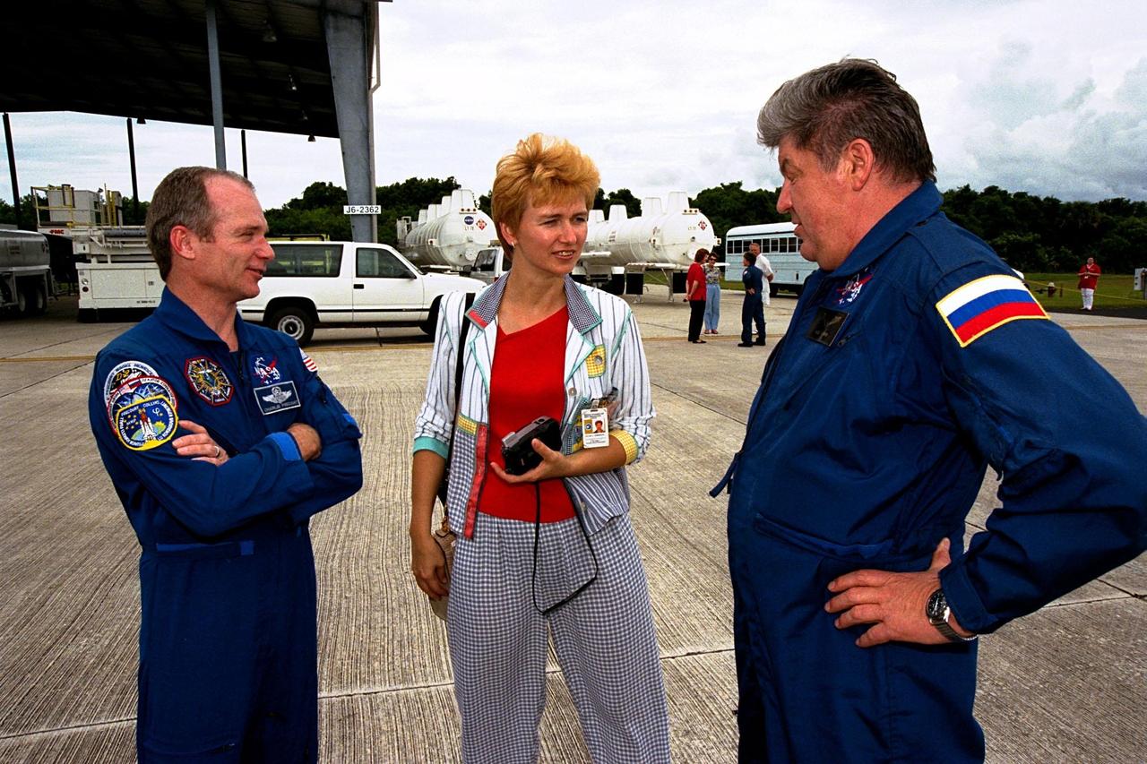 STS-91 Mission Commander Charles Precourt (left) talks to Elena V. Kondakova and her husband, Valery Ryumin, a cosmonaut with the Russian Space Agency (RSA) and STS-91 mission specialist, at Kennedy Space Center's Shuttle Landing Facility (SLF). The STS-91 crew had just arrived at the SLF aboard T-38 jets in preparation for launch. Kondakova, also a cosmonaut with the RSA, flew with Commander Precourt as a mission specialist on STS-84 which launched on May 15, 1997. STS-91 is scheduled to be launched on June 2 on Space Shuttle Discovery with a launch window opening around 6:10 p.m. EDT. The mission will feature the ninth Shuttle docking with the Russian Space Station Mir, the first Mir docking for Discovery, the conclusion of Phase I of the joint U.S.-Russian International Space Station Program, and the first flight of the new Space Shuttle super lightweight external tank. The STS-91 flight crew also includes Pilot Dominic Gorie and Mission Specialists Wendy B. Lawrence; Franklin Chang-Diaz, Ph.D.; and Janet Kavandi, Ph.D. Andrew Thomas, Ph.D., will be returning to Earth with the crew after living more than four months aboard Mir