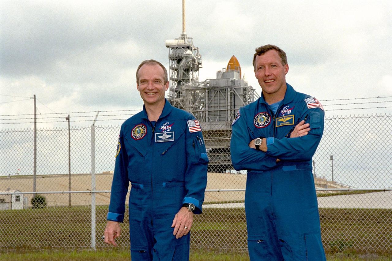 KENNEDY SPACE CENTER,  Fla. -- STS-91 Mission Commander Charles Precourt and Pilot Dominic Gorie visit Launch Pad 39A from which they are scheduled to be launched aboard Space Shuttle Discovery on June 2 around 6:10 p.m. EDT. Discovery is behind them, protected by the pad's Rotating Service Structure. The mission will feature the ninth Shuttle docking with the Russian Space Station Mir, the first Mir docking for Discovery, the conclusion of Phase I of the joint U.S.-Russian International Space Station Program, and the first flight of the new Space Shuttle super lightweight external tank. The STS-91 flight crew also includes Mission Specialists Franklin Chang-Diaz, Ph.D.; Wendy B. Lawrence; Janet Kavandi, Ph.D.; and Valery Ryumin, with the Russian Space Agency. Andrew Thomas, Ph.D., will be returning to Earth with the crew after living more than four months aboard Mir
