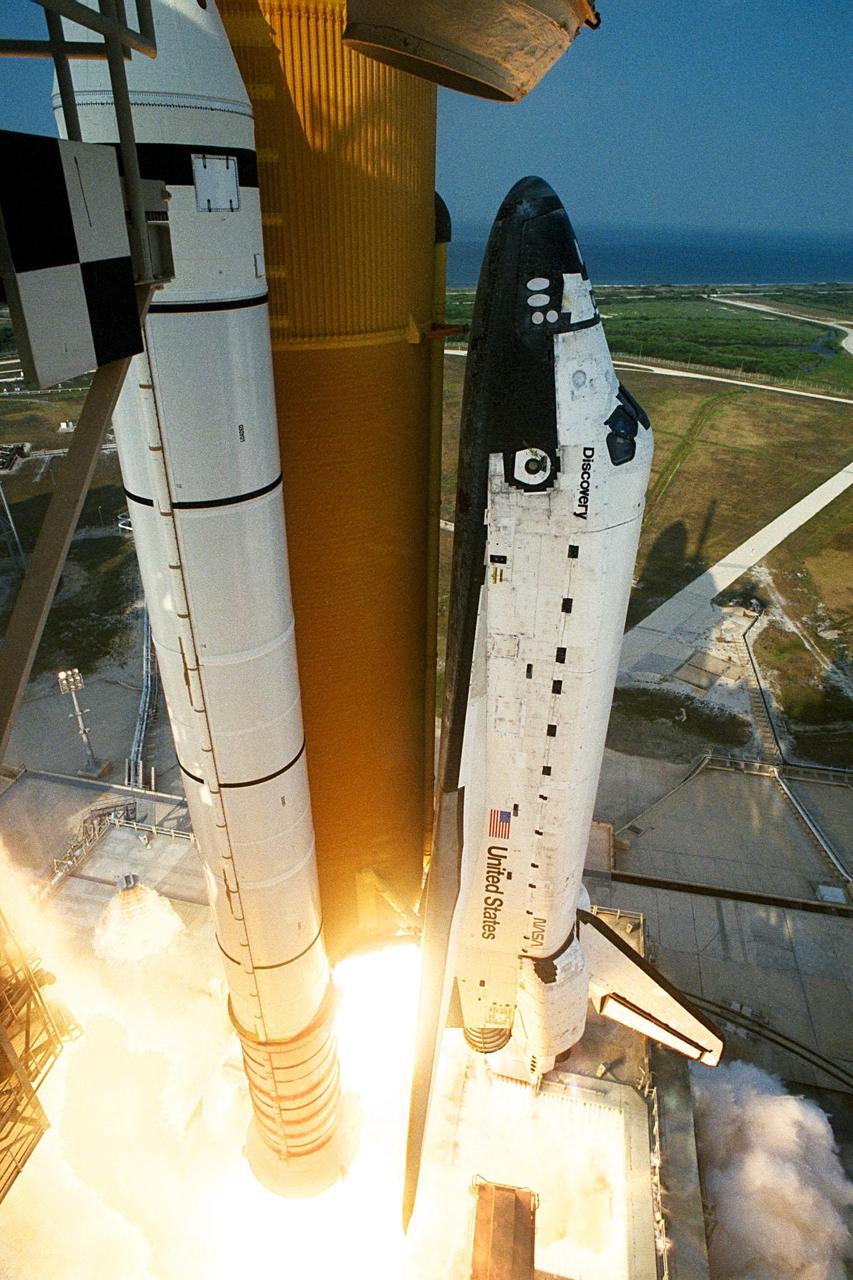 KENNEDY SPACE CENTER,  Fla. -- The last mission of the Shuttle-Mir program begins as the Space Shuttle Discovery lifts off from Launch Pad 39A at 6:06:24 p.m. EDT June 2. A torrent of water is seen flowing onto the mobile launcher platform (MLP) from numerous large quench nozzles, or "rainbirds," mounted on its surface. This water, part of the Sound Suppression System, helps protect the orbiter and its payloads from damage by acoustical energy and rocket exhaust reflected from the flame trench and MLP during launch. On board Discovery are Mission Commander Charles J. Precourt; Pilot Dominic L. Gorie; and Mission Specialists Wendy B. Lawrence, Franklin R. Chang-Diaz, Janet Lynn Kavandi and Valery Victorovitch Ryumin. The nearly 10-day mission will feature the ninth and final Shuttle docking with the Russian space station Mir, the first Mir docking for the Space Shuttle orbiter Discovery, the first on-orbit test of the Alpha Magnetic Spectrometer (AMS), and the first flight of the new Space Shuttle super lightweight external tank. Astronaut Andrew S. W. Thomas will be returning to Earth as an STS-91 crew member after living more than four months aboard Mir