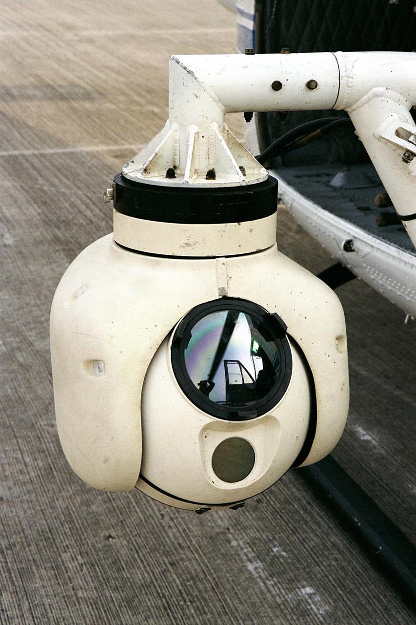 KENNEDY SPACE CENTER, FLA. --  A beach ball-sized infrared camera, part of the Forward Looking Infrared Radar (FLIR), has been mounted on the right siderail of NASA's Huey UH-1 helicopter. The helicopter has also been outfitted with a portable global positioning satellite (GPS) system to support Florida's Division of Forestry as they fight the brush fires which have been plaguing the state as a result of extremely dry conditions and lightning storms. The FLIR also includes a real-time television monitor and recorder installed inside the helicopter. While the FLIR collects temperature data and images, the GPS system provides the exact coordinates of the fires being observed and transmits the data to the firefighters on the ground. The Kennedy Space Center (KSC) security team routinely uses the FLIR equipment prior to Shuttle launch and landing activities to ensure that the area surrounding the launch pad and runway are clear of unauthorized personnel. KSC's Base Operations Contractor, EG&G Florida, operates the NASA-owned helicopter