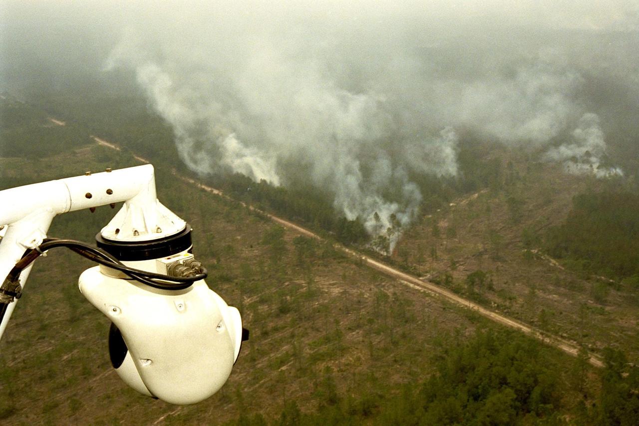 KENNEDY SPACE CENTER, FLA. --  A beach ball-sized infrared camera, part of the Forward Looking Infrared Radar (FLIR), has been mounted on the right siderail of NASA's Huey UH-1 helicopter and is being used to scan a large area of Volusia County, Florida, where a fire burns. The helicopter has also been outfitted with a portable global positioning satellite (GPS) system to support Florida's Division of Forestry as they fight the brush fires which have been plaguing the state as a result of extremely dry conditions and lightning storms. The FLIR also includes a real-time television monitor and recorder installed inside the helicopter. While the FLIR collects temperature data and images, the GPS system provides the exact coordinates of the fires being observed and transmits the data to the firefighters on the ground. The Kennedy Space Center (KSC) security team routinely uses the FLIR equipment prior to Shuttle launch and landing activities to ensure that the area surrounding the launch pad and runway are clear of unauthorized personnel. KSC's Base Operations Contractor, EG&G Florida, operates the NASA-owned helicopter