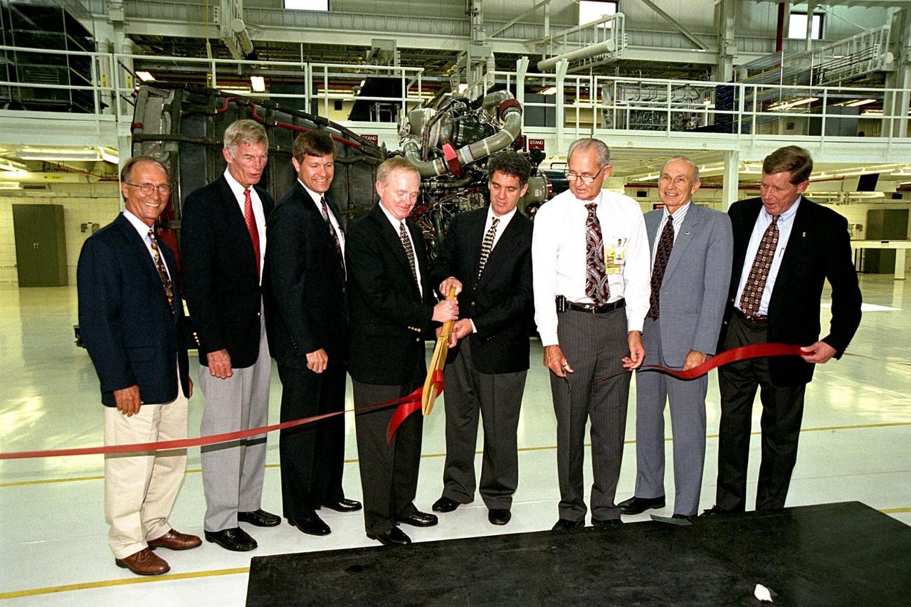 KSC Center Director Roy D. Bridges Jr. and U.S. Congressman Dave Weldon (holding scissors) cut the ribbon at a ceremony on July 6 to open KSC's new 34,600-square-foot Space Shuttle Main Engine Processing Facility (SSMEPF). Joining in the ribbon cutting are (left) Ed Adamek, vice president and associate program manager for Ground Operations of United Space Alliance; Marvin L. Jones, director of Installation Operations; Donald R. McMonagle, manager of Launch Integration; (right) Wade Ivey of Ivey Construction, Inc.; Robert B. Sieck, director of Shuttle Processing; and John Plowden, vice president of Rocketdyne. A major addition to the existing Orbiter Processing Facility Bay 3, the SSMEPF replaces the Shuttle Main Engine Shop located in the Vehicle Assembly Building (VAB). The decision to move the shop out of the VAB was prompted by safety considerations and recent engine processing improvements. The first three main engines to be processed in the new facility will fly on Shuttle Endeavour's STS-88 mission in December 1998