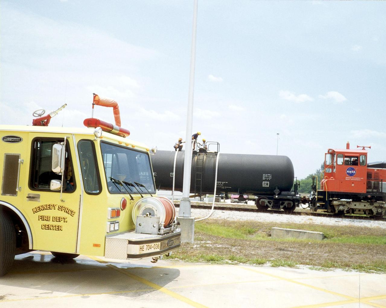 A Kennedy Space Center railroad tanker car loaded with 20,000 gallons of water and retrofitted with a special attachment for directly filling fire trucks was transported to the scene of a fire in north Brevard County to assist with firefighting efforts
