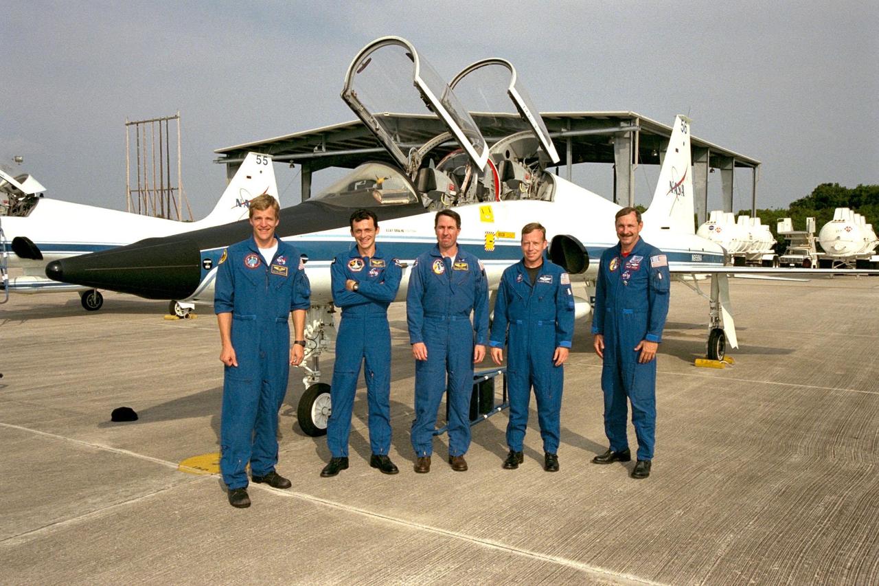 Members of the STS-95 crew pose in front of one of the T-38 jet aircraft that brought them to the Shuttle Landing Facility at KSC. From left, the members are Mission Specialist Scott E. Parazynski, M.D.; Pedro Duque of Spain, representing the European Space Agency (ESA); Mission Specialist Stephen K. Robinson, Ph.D.; Pilot Steven W. Lindsey; and Commander Curtis L. Brown Jr. The crew is participating in a familiarization tour of the SPACEHAB module and the equipment that will fly with them on the Space Shuttle Discovery scheduled to launch Oct. 29, 1998. The mission includes research payloads such as the Spartan solar-observing deployable spacecraft, the Hubble Space Telescope Orbital Systems Test Platform, the International Extreme Ultraviolet Hitchhiker, as well as the SPACEHAB single module with experiments on space flight and the aging process