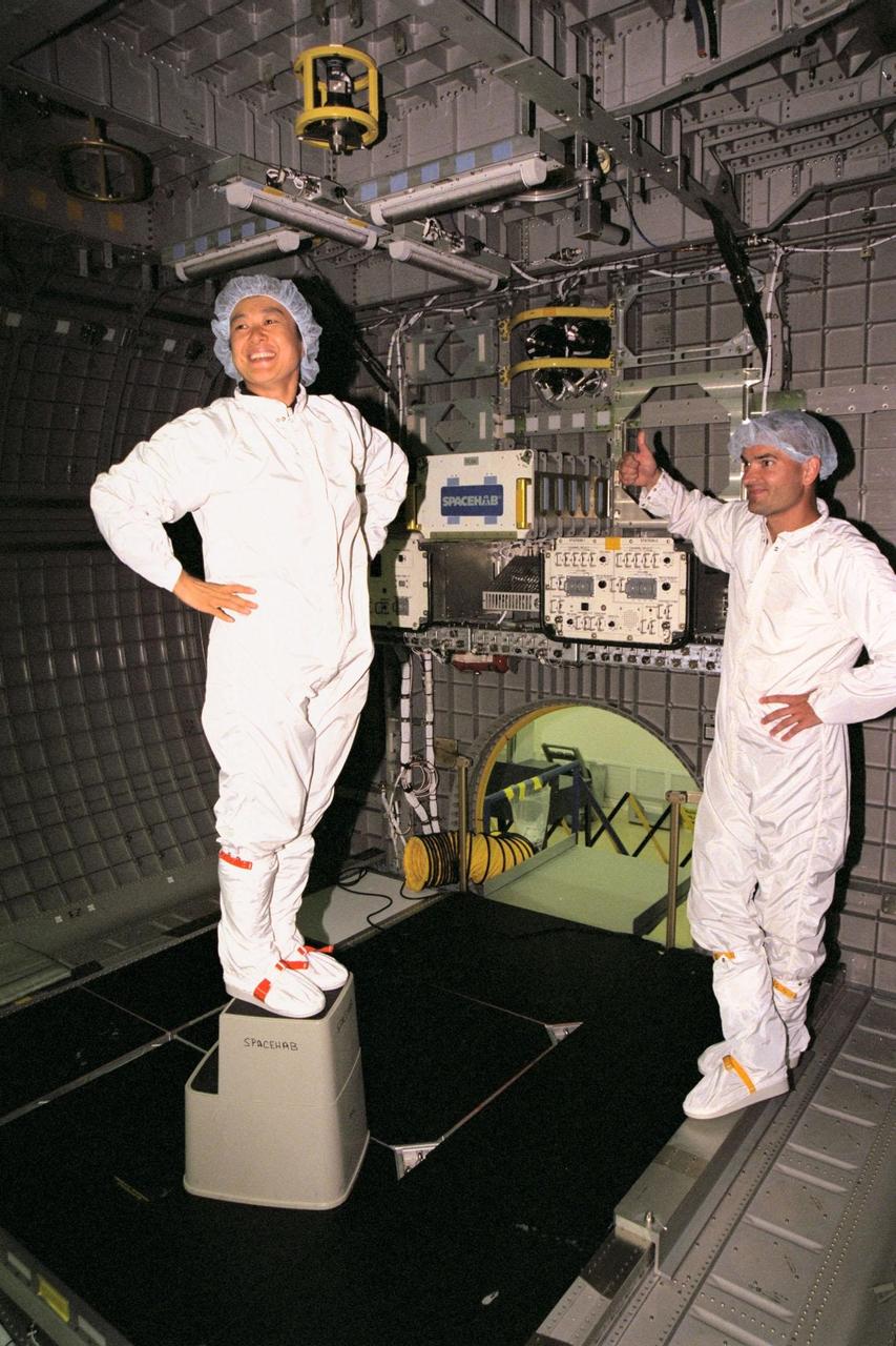 STS-95 Payload Specialist Chiaki Mukai, representing National Space Development Agency of Japan (NASDA), grins for the camera after looking at equipment in the SPACEHAB module while Chris Jaskolka, of Boeing SPACEHAB, gives her a thumbs up. The STS-95 crew is at KSC for a familiarization tour of the SPACEHAB module and the equipment that will fly with them on the Space Shuttle Discovery scheduled to launch Oct. 29, 1998. The mission includes research payloads such as the Spartan solar-observing deployable spacecraft, the Hubble Space Telescope Orbital Systems Test Platform, the International Extreme Ultraviolet Hitchhiker, as well as the SPACEHAB single module with experiments on space flight and the aging process