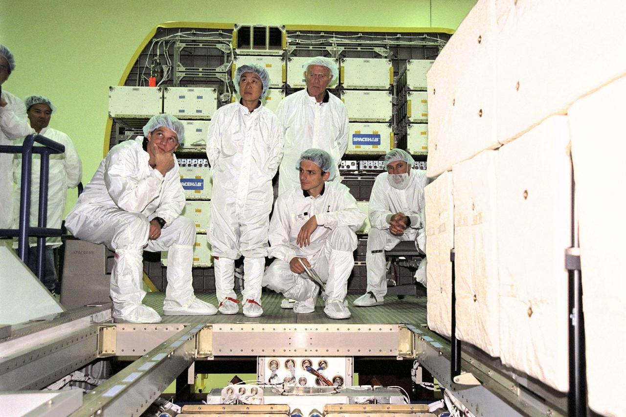 The STS-95 crew members Mission Specialist Scott E. Parazynski, Payload Specialists Chiaki Mukai and John H. Glenn Jr., Mission Specialist Pedro Duque and Commander Curtis L. Brown Jr. look at the inside of the SPACEHAB module at the SPACEHAB Payload Processing Facility, Cape Canaveral, Fla. The crew is on a familiarization tour of the module and equipment that will fly with them on the Space Shuttle Discovery scheduled to launch Oct. 29, 1998. The mission includes research payloads such as the Spartan solar-observing deployable spacecraft, the Hubble Space Telescope Orbital Systems Test Platform, the International Extreme Ultraviolet Hitchhiker, as well as the SPACEHAB single module with experiments on space flight and the aging process