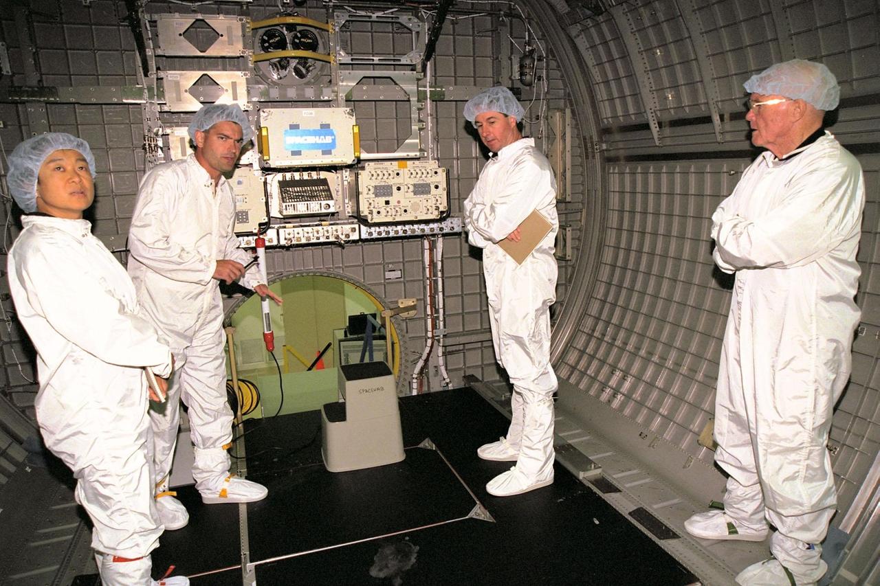 KENNEDY SPACE CENTER, FLA. -- STS-95 crew members get a briefing on equipment inside the SPACEHAB module from Chris Jaskolka of Boeing, second from left. Listening intently are crew members, from left, Payload Specialist Chiaki Mukai, representing the National Space Development Agency of Japan (NASDA); Mission Specialist Stephen K. Robinson; and Payload Specialist John H. Glenn Jr., who also is a senator from Ohio. STS-95 will feature a variety of research payloads, including the Spartan solar-observing deployable spacecraft, the Hubble Space Telescope Orbital Systems Platform, the International Extreme Ultraviolet Hitchhiker, and experiments on space flight and the aging process. STS-95 is targeted for an Oct. 29 launch aboard the Space Shuttle Discovery