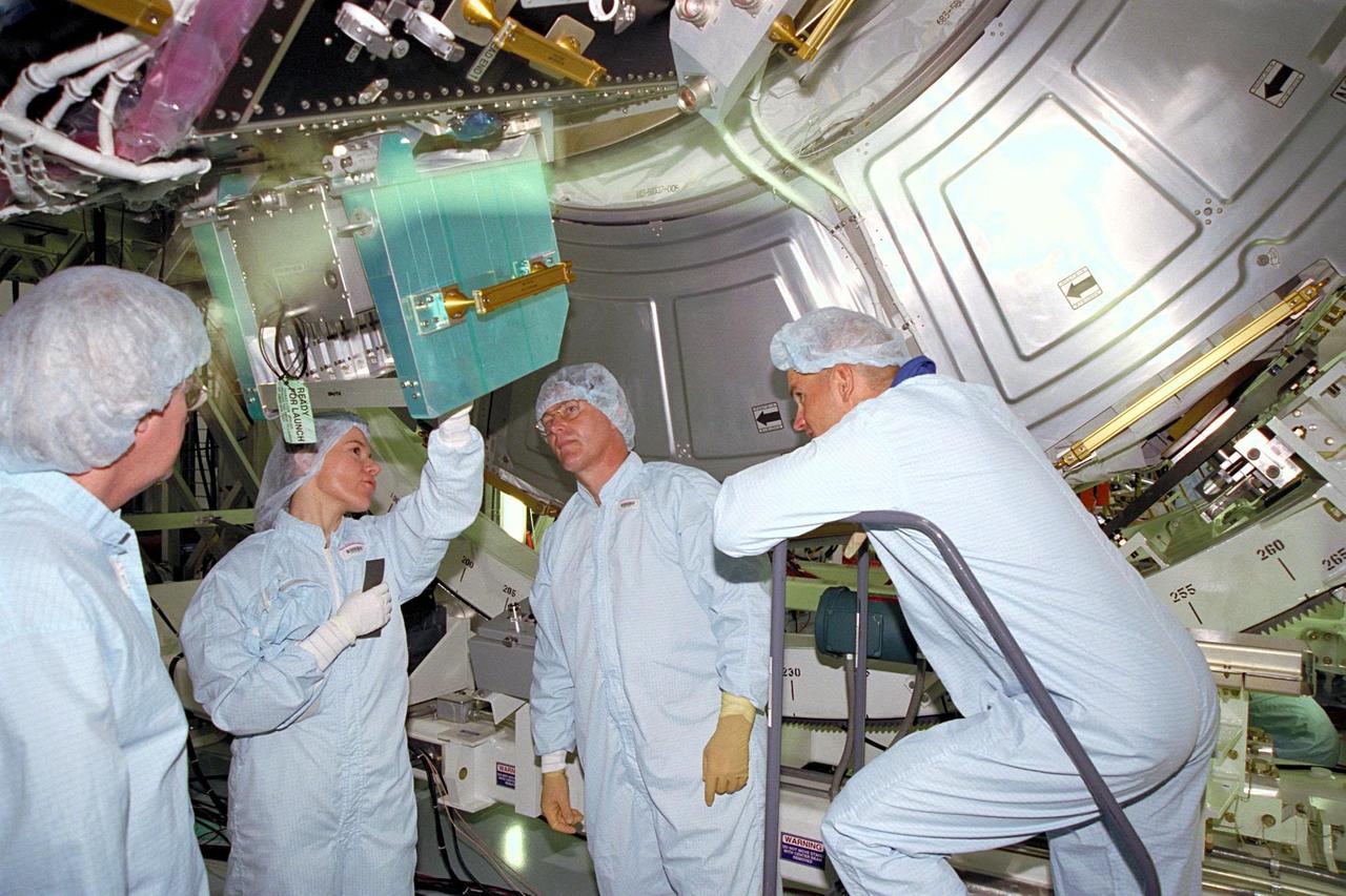 KENNEDY SPACE CENTER, FLA. -- As part of the Crew Equipment Interface Test (CEIT), Boeing Structural Engineer Karry Switzer (second from left) shows part of the Unity connecting module to STS-88 crew members Mission Specialist Jerry L. Ross and Pilot Rick W. Sturckow in the Space Station Processing Facility at KSC. The Unity connecting module, part of the International Space Station, will be mated to the Zarya control module, which will already be in orbit. The CEIT gives astronauts an opportunity for a hands-on look at the payloads on which they will be working while on orbit. STS-88 will be the first Space Shuttle launch for the International Space Station. Launch is scheduled for December 1998