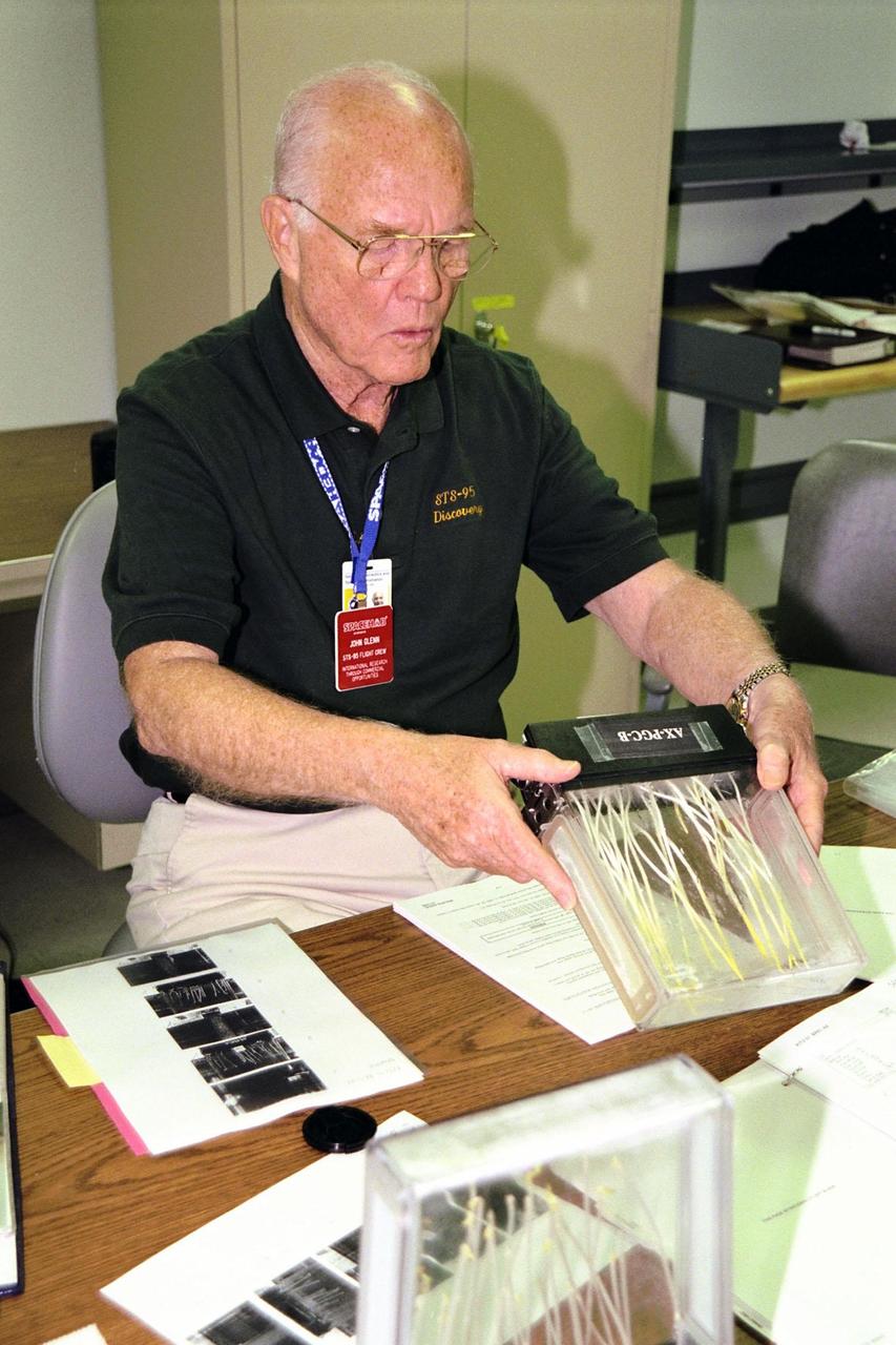 KENNEDY SPACE CENTER, FLA. -- STS-95 Payload Specialist John H. Glenn Jr., who also is a senator from Ohio, works with the Biological Research in Canisters (BRIC) experiment which will be flown on the mission. Glenn and other STS-95 crew members were at KSC and the adjacent SPACEHAB Payload Processing Facility in Cape Canaveral to familiarize themselves with the payloads which will fly on the mission. STS-95 will feature a variety of research payloads, including the Spartan solar-observing deployable spacecraft, the Hubble Space Telescope Orbital Systems Platform, the International Extreme Ultraviolet Hitchhiker, and experiments on space flight and the aging process. STS-95 is targeted for an Oct. 29 launch aboard the Space Shuttle Discovery