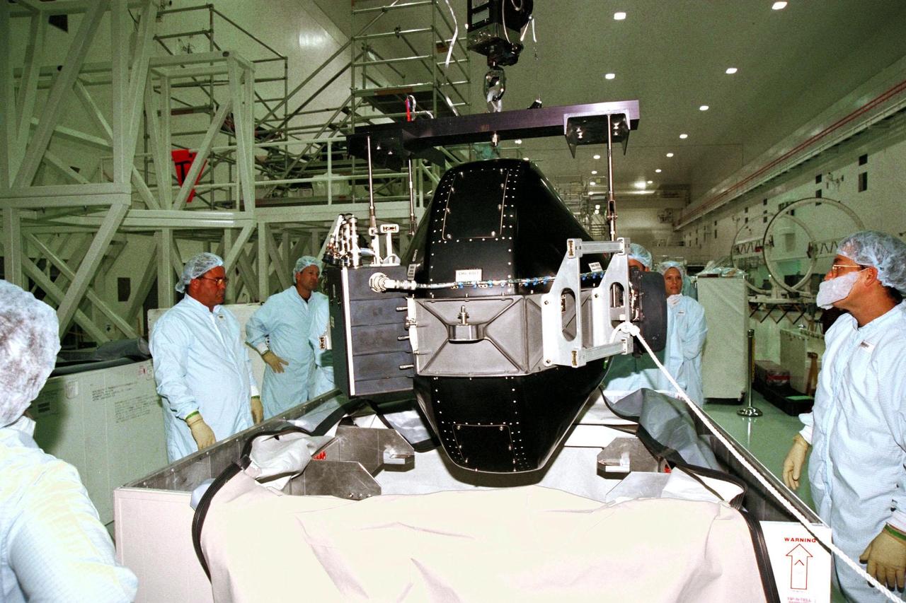 Boeing technicians remove the cover from a Control Moment Gyroscope (CMG) in the Space Station Processing Facility at KSC. The CMG will be attached to the Integrated Truss Structure (ITS) Z1. Gyroscopes are used for stabilization of the International Space Station (ISS). The CMG and Z1, part of the construction of the ISS, will be carried on STS-92, the third U.S. flight planned for on-orbit construction of the ISS. STS-92 is scheduled for liftoff on June 17, 1999, aboard the Space Shuttle Atlantis
