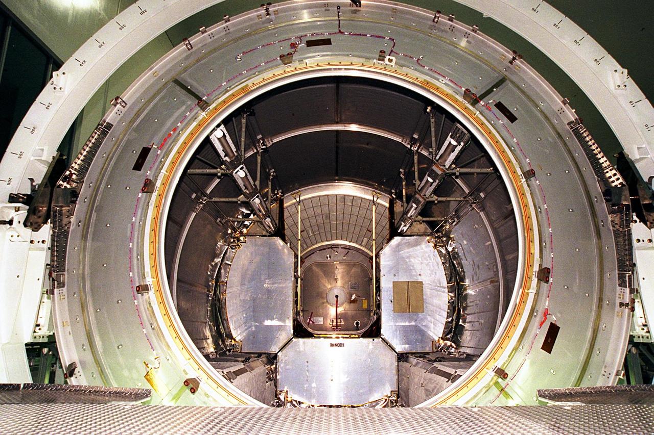 KENNEDY SPACE CENTER, FLA. -- The inside of the first Multi-Purpose Logistics Module (MPLM) for the International Space Station (ISS) is seen after the end cap is removed. The Italian-built module, named Leonardo, is undergoing testing at the Space Station Processing Facility. It is one of three from Alenia Aerospazio, and will be operated by NASA and supported by ASI, the Italian space agency. The MPLMs will be carried in the payload bay of a Shuttle orbiter, and will provide storage and additional work space for up to two astronauts when docked to the ISS. Leonardo is scheduled to be launched on STS-100 in December 1999. The second MPLM, named Raffaello, is scheduled to be handed over in April 1999. A third module, to be named Donatello, is due to be delivered in October 2000 for launch in January 2001