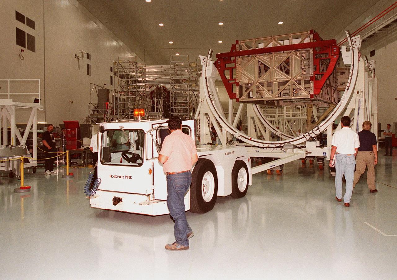 An Integrated Equipment Assembly (IEA) is moved into the center of the Space Station Processing Facility clean room at KSC for transition to the high bay. The IEA, a large truss segment of the International Space Station (ISS), is one of four power modules to be used on the International Space Station. The modules contain batteries for the ISS solar panels and power for the life support systems and experiments that will be conducted. This first IEA will fly on the Space Shuttle Endeavour as part of STS-97, scheduled to launch August 5, 1999