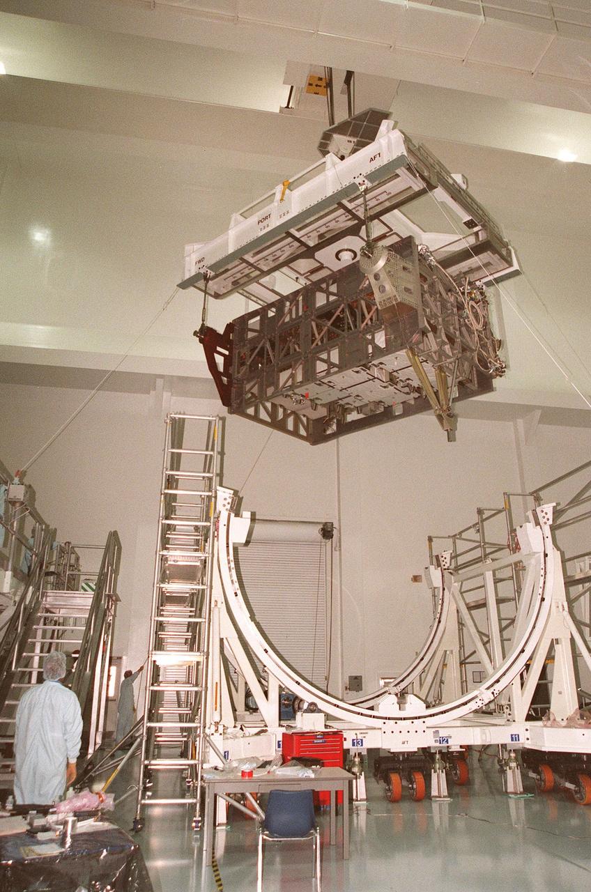 An Integrated Equipment Assembly (IEA) is lifted from a rotation stand in the Space Station Processing Facility at KSC to be placed on a work stand. The IEA, a large truss segment of the International Space Station (ISS), is one of four power modules to be used on the International Space Station. The modules contain batteries for the ISS solar panels and power for the life support systems and experiments that will be conducted. This first IEA will fly on the Space Shuttle Endeavour as part of STS-97, scheduled to launch August 5, 1999