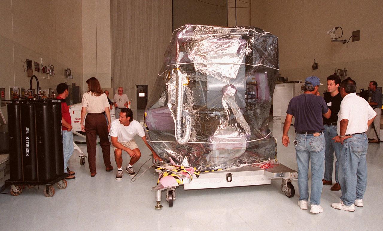 KENNEDY SPACE CENTER, FLA. -- NASA’s Deep Space 1 spacecraft waits in the Payload Hazardous Servicing Facility for prelaunch processing. Targeted for launch on a Boeing Delta 7326 rocket on Oct. 15, 1998, the first flight in NASA’s New Millennium Program is designed to validate 12 new technologies for scientific space missions of the next century. Onboard experiments include an ion propulsion engine and software that tracks celestial bodies so the spacecraft can make its own navigation decisions without the intervention of ground controllers. Deep Space 1 will complete most of its mission objectives within the first two months, but will also do a flyby of a near-Earth asteroid, 1992 KD, in July 1999