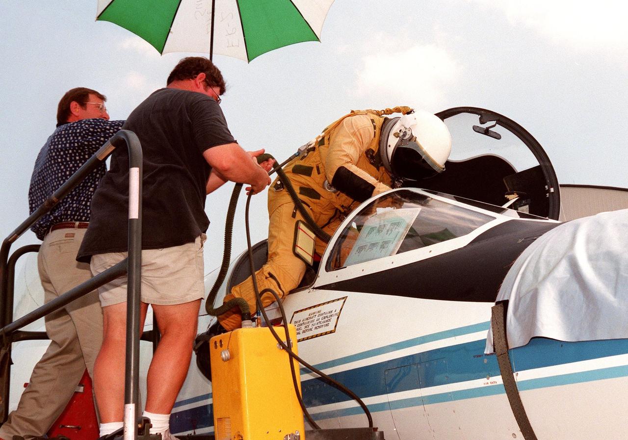The pilot climbs into the cockpit of a high-altitude research plane, a specially equipped Dryden Flight Research Center ER-2 (a modified U-2), at Patrick Air Force Base. Soaring above 65,000 feet, the ER-2 will measure the structure of hurricanes and the surrounding atmosphere that steers the storm’s movement. The plane is part of the NASA-led Atmospheric Dynamics and Remote Sensing program that includes other government weather researchers and the university community in a study of Atlantic hurricanes and tropical storms. The hurricane study, which lasts through September 1998, is part of NASA’s Earth Science enterprise to better understand the total Earth system and the effects of natural and human-induced changes on the global environment