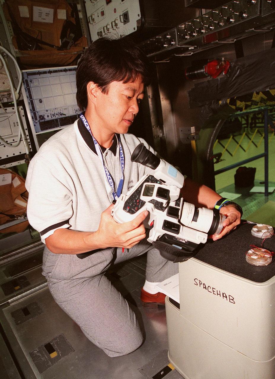 KENNEDY SPACE CENTER, FLA. -- STS-95 Payload Specialist Chiaki Mukai, representing the National Space Development Agency of Japan (NASDA), looks over part of the equipment for the SPACEHAB during familiarization at the SPACEHAB Payload Processing Facility, Cape Canaveral. The mission, scheduled to launch Oct. 29, includes research payloads such as the Spartan solar-observing deployable spacecraft, the Hubble Space Telescope Orbital Systems Test Platform, the International Extreme Ultraviolet Hitchhiker, as well as the SPACEHAB single module with experiments on space flight and the aging process