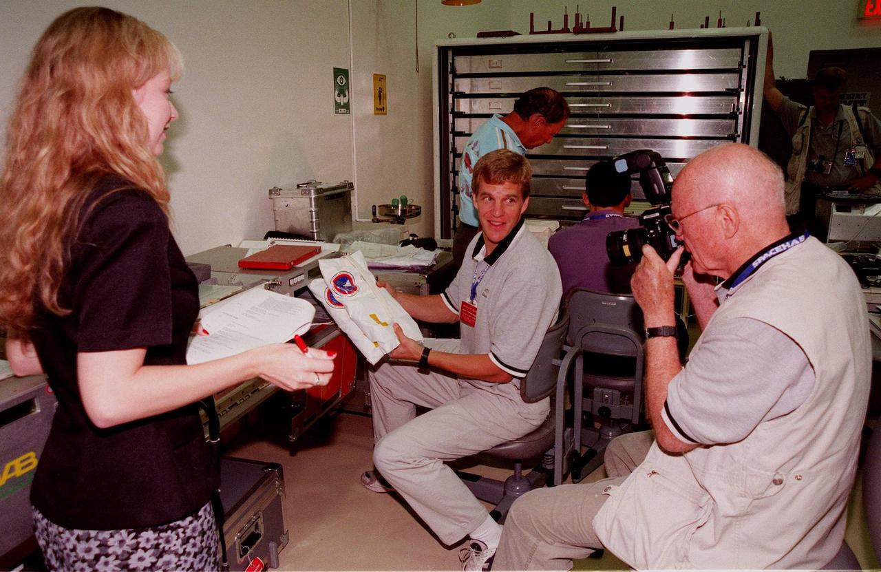 KENNEDY SPACE CENTER, FLA. -- In the SPACEHAB Payload Processing Facility (SPPF), Niki Myers, with BioDyn, watches while Mission Specialist Scott Parazynski, M.D. (center) and Payload Specialist John Glenn (right), who is a senator from Ohio, look over equipment for the mission scheduled to launch Oct. 29. STS-95 crew members have been participating in SPACEHAB familiarization in the SPPF. Scheduled to launch Oct. 29, the mission includes research payloads such as the Spartan solar-observing deployable spacecraft, the Hubble Space Telescope Orbital Systems Test Platform, the International Extreme Ultraviolet Hitchhiker, as well as the SPACEHAB single module with experiments on space flight and the aging process