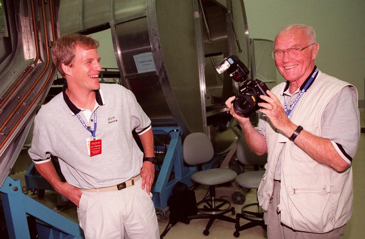 KENNEDY SPACE CENTER, FLA. -- In the SPACEHAB Payload Processing Facility (SPPF), STS-95 Mission Specialist Scott Parazynski, M.D., (left) and Payload Specialist John Glenn (right), who is a senator from Ohio, share a light moment while checking out equipment for the mission, scheduled to launch Oct. 29. STS-95 crew members have been participating in SPACEHAB familiarization in the SPPF. The mission includes research payloads such as the Spartan solar-observing deployable spacecraft, the Hubble Space Telescope Orbital Systems Test Platform, the International Extreme Ultraviolet Hitchhiker, as well as the SPACEHAB single module with experiments on space flight and the aging process