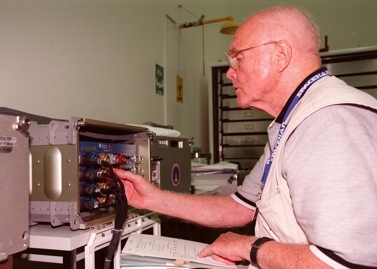 KENNEDY SPACE CENTER, FLA. -- In the SPACEHAB Payload Processing Facility (SPPF), STS-95 Payload Specialist John Glenn, who is a senator from Ohio, checks out equipment for the mission scheduled to launch Oct. 29. He and other STS-95 crew members have been participating in SPACEHAB familiarization in the SPPF. The mission includes research payloads such as the Spartan solar-observing deployable spacecraft, the Hubble Space Telescope Orbital Systems Test Platform, the International Extreme Ultraviolet Hitchhiker, as well as the SPACEHAB single module with experiments on space flight and the aging process