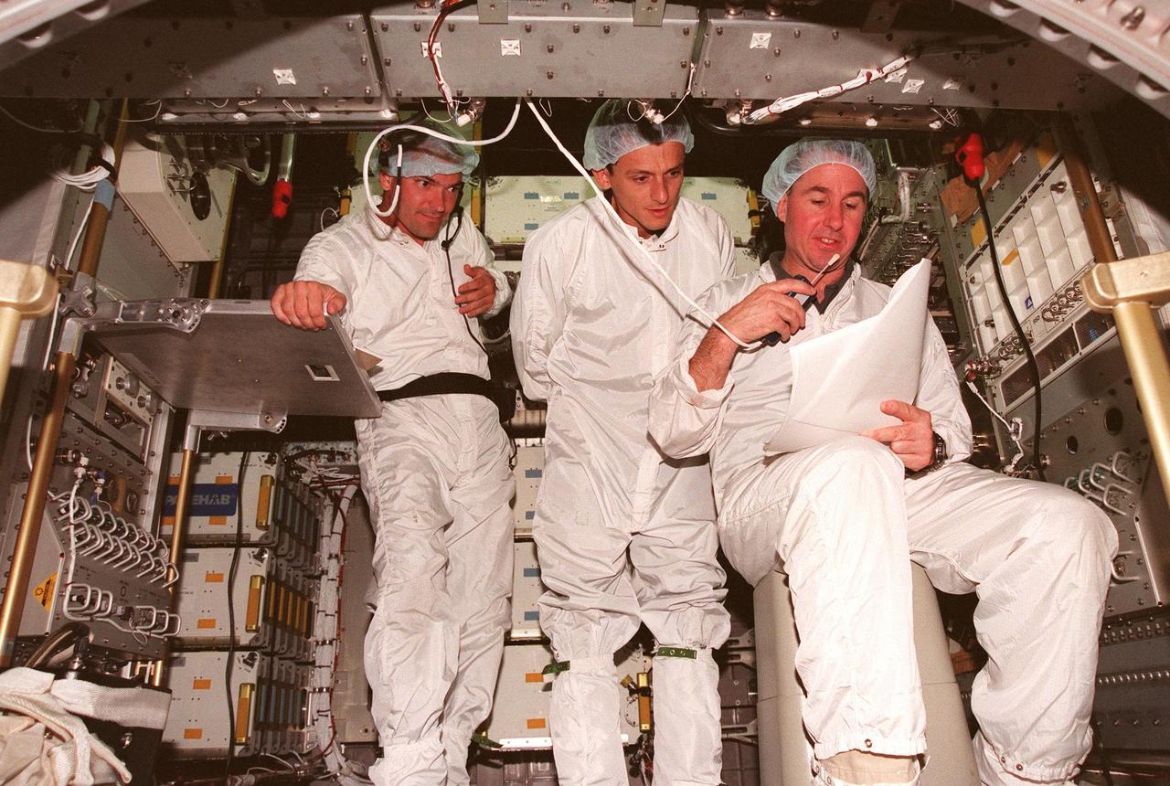 KENNEDY SPACE CENTER, FLA. -- Chris Jaskolka, of Boeing SPACEHAB, and STS-95 Mission Specialists Pedro Duque of Spain, who represents the European Space Agency (ESA), and Stephen Robinson, Ph.D., test equipment inside the SPACEHAB in the SPACEHAB Payload Processing Facility (SPPF). STS-95 crew members have been participating in SPACEHAB familiarization in the SPPF. Scheduled to launch Oct. 29, the mission includes research payloads such as the Spartan solar-observing deployable spacecraft, the Hubble Space Telescope Orbital Systems Test Platform, the International Extreme Ultraviolet Hitchhiker, as well as the SPACEHAB single module with experiments on space flight and the aging process