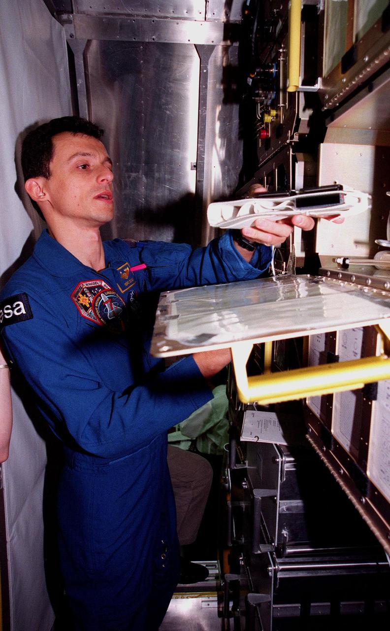 KENNEDY SPACE CENTER, FLA. -- STS-95 Mission Specialist Pedro Duque of Spain, representing the European Space Agency (ESA), checks out equipment inside the SPACEHAB module at the SPACEHAB Payload Processing Facility (SPPF), Cape Canaveral. The STS-95 crew are participating in SPACEHAB familiarization at the SPPF. The mission, scheduled to launch Oct. 29, includes research payloads such as the Spartan solar-observing deployable spacecraft, the Hubble Space Telescope Orbital Systems Test Platform, the International Extreme Ultraviolet Hitchhiker, as well as the SPACEHAB single module with experiments on space flight and the aging process