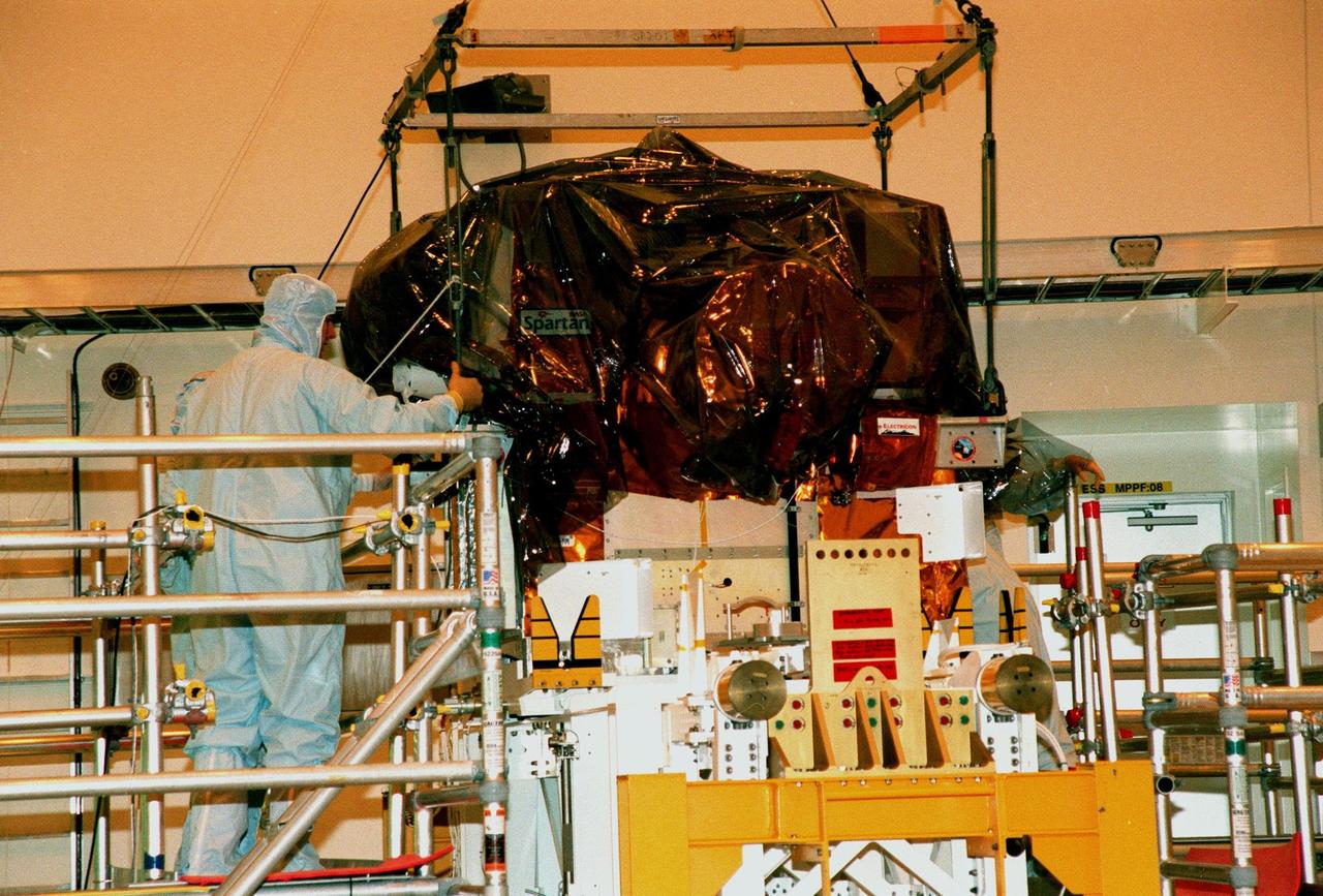 The Spartan solar-observing deployable spacecraft is moved from a bridge in the Multi-Payload Processing Facility at KSC where it had been stored for protection from a hurricane threatening the area. Spartan is one of the payloads for the STS-95 mission, scheduled to launch Oct. 29. Other research payloads include the Hubble Space Telescope Orbital Systems Test Platform, the International Extreme Ultraviolet Hitchhiker, as well as the SPACEHAB single module with experiments on space flight and the aging process