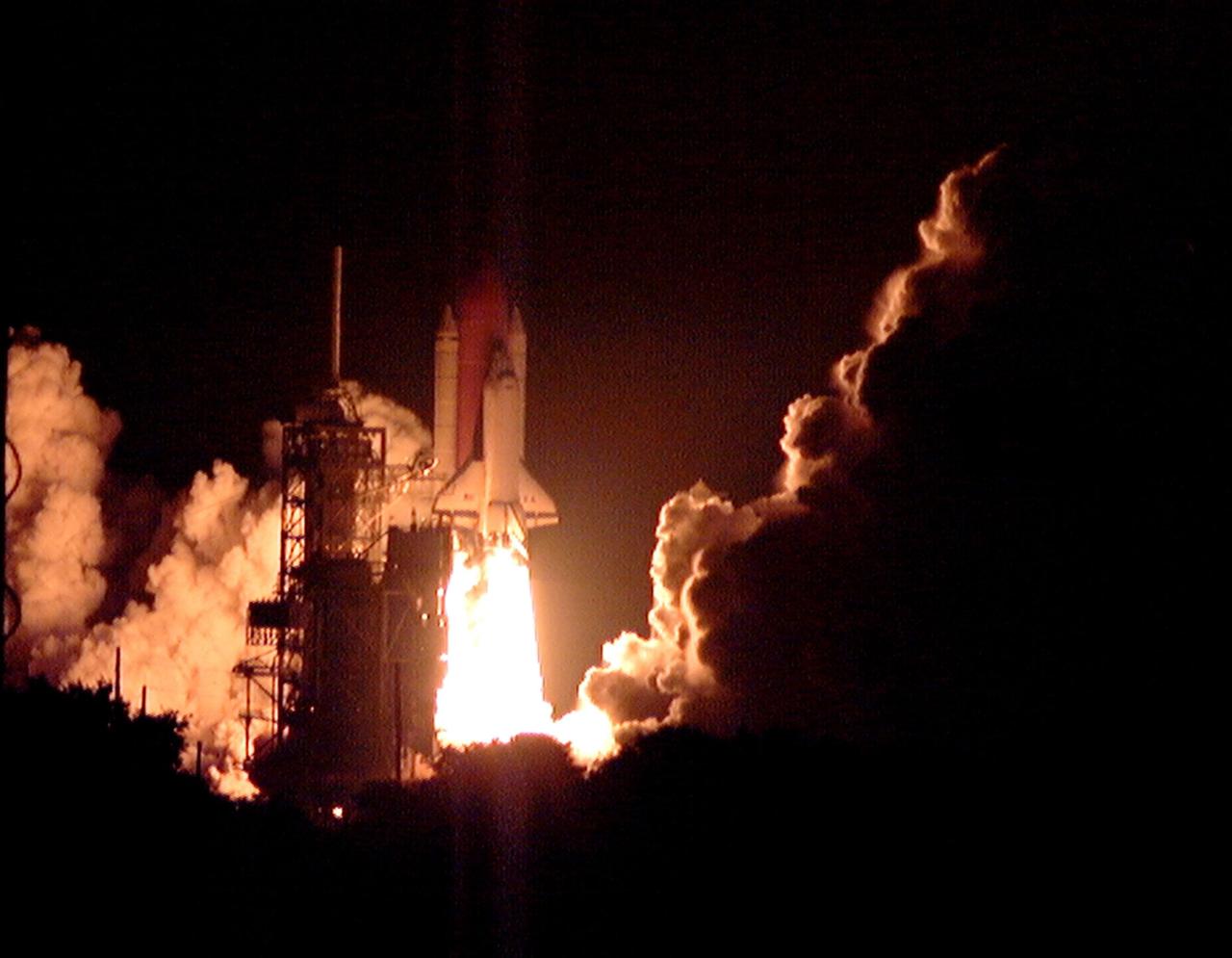 Space Shuttle Columbia gushes a stream of fire whose light fills the black sky on its successful liftoff from Launch Pad 39-B on mission STS-93. Liftoff occurred at 12:31 a.m. EDT. STS-93 is a five-day mission primarily to release the Chandra X-ray Observatory, which will allow scientists from around the world to study some of the most distant, powerful and dynamic objects in the universe. The crew numbers five: Commander Eileen M. Collins, Pilot Jeffrey S. Ashby, and Mission Specialists Stephen A. Hawley (Ph.D.), Catherine G. Coleman (Ph.D.) and Michel Tognini of France, with the Centre National d'Etudes Spatiales (CNES). Collins is the first woman to serve as commander of a Shuttle mission. The target landing date is July 27, 1999, at 11:20 p.m. EDT