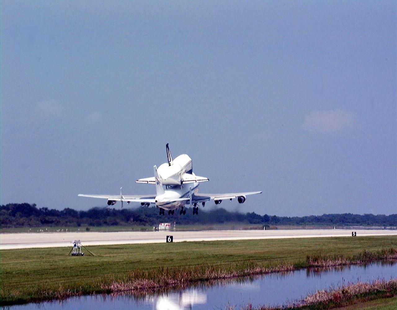 KENNEDY SPACE CENTER, FLA. -- At the Shuttle Landing Facility at Kennedy Space Center, the orbiter Columbia takes off into a clear sky on the back of a Boeing 747 Shuttle Carrier Aircraft on a ferry flight to Palmdale, Calif. On the rear of the orbiter can be seen the tail cone, a fairing that is installed over the aft fuselage of the orbiter to decrease aerodynamic drag and buffet when the Shuttle Carrier Aircraft is transporting the orbiter cross-country. It is 36 feet long, 25 feet wide, and 22 feet high. Columbia, the oldest of four orbiters in NASA's fleet, will undergo extensive inspections and modifications in Boeing's Orbiter Assembly Facility during a nine-month orbiter maintenance down period (OMDP), the second in its history. Orbiters are periodically removed from flight operations for an OMDP. Columbia's first was in 1994. Along with more than 100 modifications on the vehicle, Columbia will be the second orbiter to be outfitted with the multifunctional electronic display system, or "glass cockpit." Columbia is expected to return to KSC in July 2000