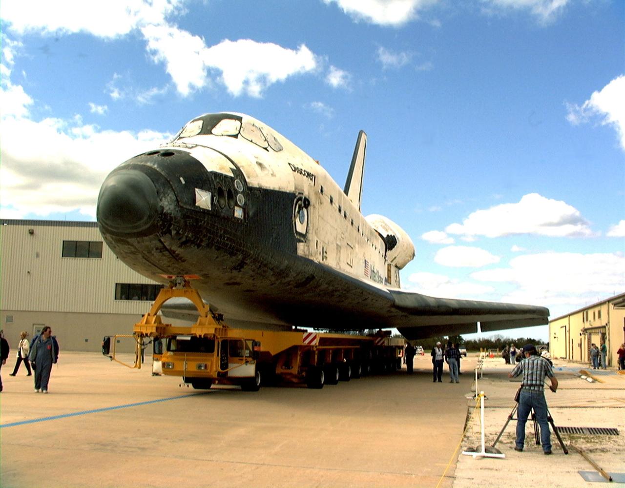 KENNEDY SPACE CENTER, FLA. -- Orbiter Discovery is moved from the Orbiter Processing Facility bay 1 (at left) to the Vehicle Assembly Building for mating with an external tank and solid rocket boosters. Launch date for Discovery on mission STS-103, the third Hubble Space Telescope servicing mission, is under review for early December. The mission is a "call-up" due to the need to replace portions of the pointing system, the gyros, which have begun to fail on the Hubble Space Telescope. Although Hubble is operating normally and conducting its scientific observations, only three of its six gyroscopes are working properly. The gyroscopes allow the telescope to point at stars, galaxies and planets. The STS-103 crew will also be replacing a Fine Guidance Sensor and an older computer with a new enhanced model, an older data tape recorder with a solid-state digital recorder, a failed spare transmitter with a new one, and degraded insulation on the telescope with new thermal insulation. The crew will also install a Battery Voltage/Temperature Improvement Kit to protect the spacecraft batteries from overcharging and overheating when the telescope goes into a safe mode