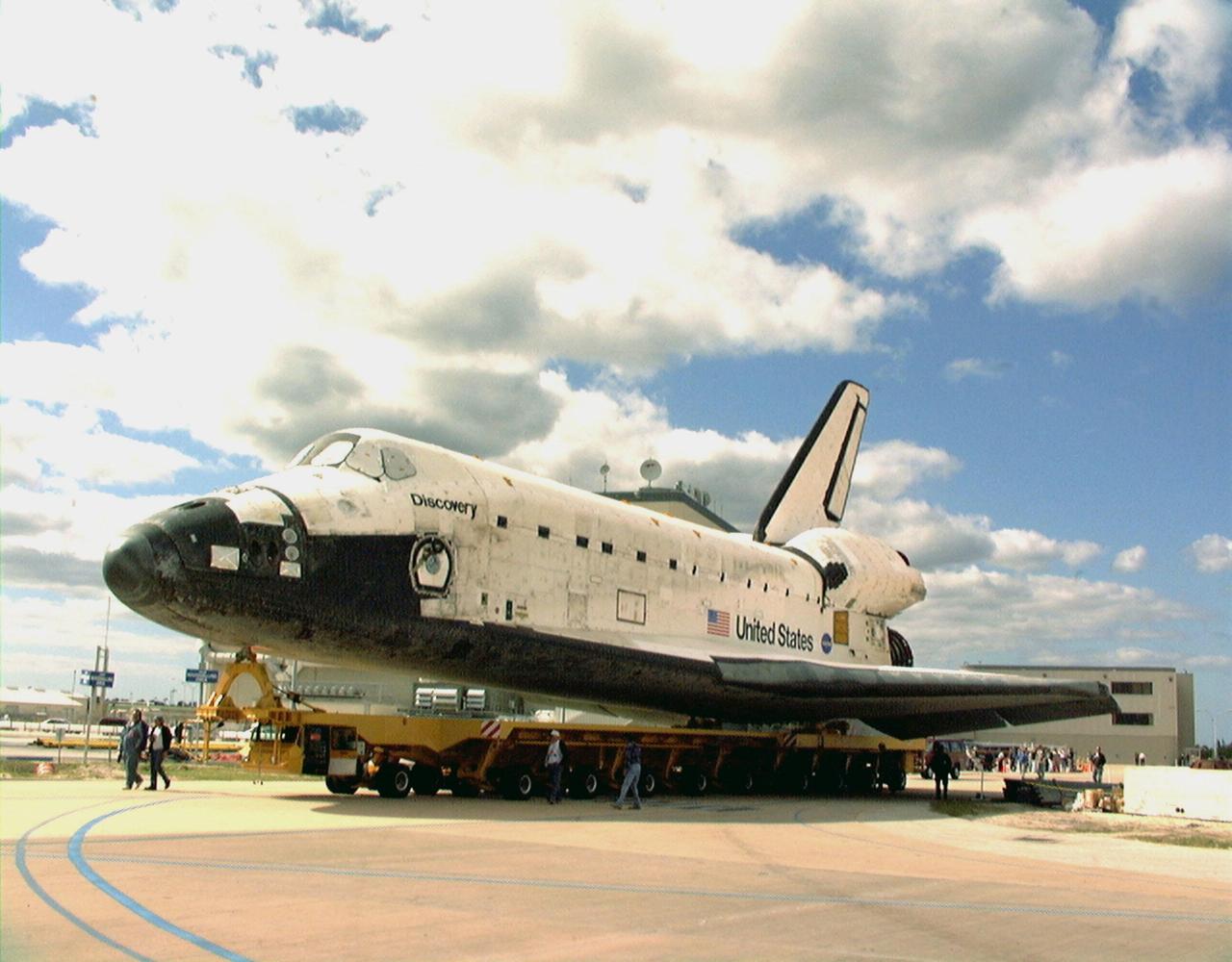 KENNEDY SPACE CENTER, FLA. -- Orbiter Discovery is rolled over to the Vehicle Assembly Building from the Orbiter Processing Facility bay 1. In the VAB it will be mated with an external tank and solid rocket boosters for its launch on mission STS-103. The launch date is currently under review for early December. STS-103, the third Hubble Space Telescope servicing mission, is a "call-up" due to the need to replace portions of the pointing system, the gyros, which have begun to fail on the Hubble Space Telescope. Although Hubble is operating normally and conducting its scientific observations, only three of its six gyroscopes are working properly. The gyroscopes allow the telescope to point at stars, galaxies and planets. The STS-103 crew will also be replacing a Fine Guidance Sensor and an older computer with a new enhanced model, an older data tape recorder with a solid-state digital recorder, a failed spare transmitter with a new one, and degraded insulation on the telescope with new thermal insulation. The crew will also install a Battery Voltage/Temperature Improvement Kit to protect the spacecraft batteries from overcharging and overheating when the telescope goes into a safe mode