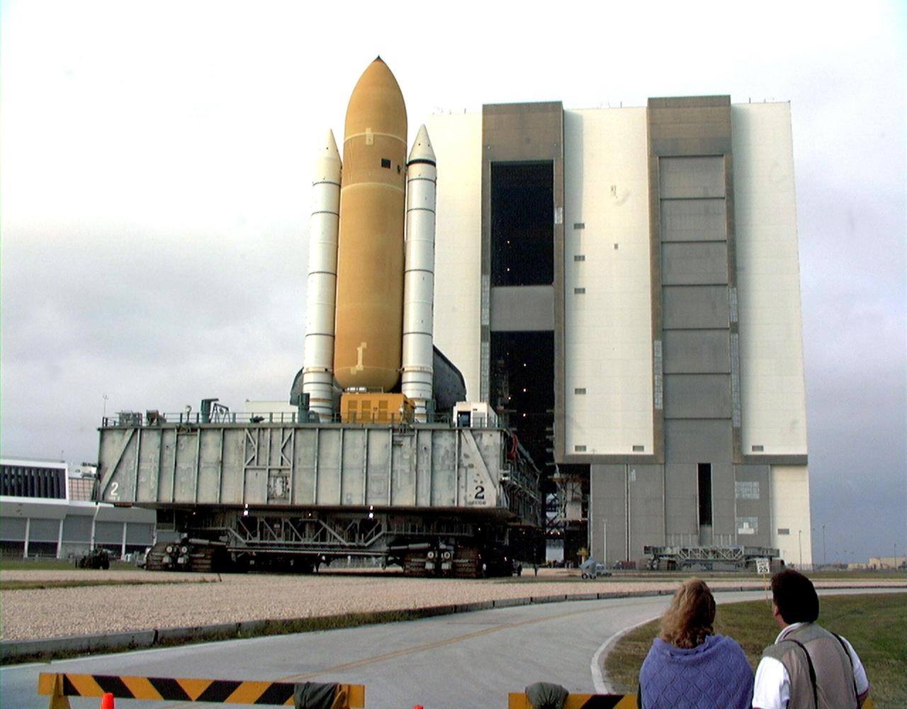KENNEDY SPACE CENTER, FLA. -- Towering atop the mobile launcher platform and crawler transporter, Space Shuttle Discovery rolls out of the Vehicle Assembly Building on its way to Launch Pad 39B. While at the pad, the orbiter, external tank and solid rocket boosters will undergo final preparations for the STS-103 launch targeted for Dec. 6, 1999, at 2:37 a.m. EST. The mission is a "call-up" due to the need to replace portions of the pointing system the gyros which have begun to fail on the Hubble Space Telescope. Although Hubble is operating normally and conducting its scientific observations, only three of its six gyroscopes are working properly. The gyroscopes allow the telescope to point at stars, galaxies and planets. The STS-103 crew will also be installing a Fine Guidance Sensor, a new enhanced computer, a solid-state digital recorder, and a new spare transmitter to replace older equipment, and replacing degraded insulation on the telescope with new thermal insulation. The crew will also install a Battery Voltage/Temperature Improvement Kit to protect the spacecraft batteries from overcharging and overheating when the telescope goes into a safe mode. Four EVA's are planned to make the necessary repairs and replacements on the telescope. Comprising the STS-103 crew are Commander Curtis L. Brown Jr., Pilot Scott J. Kelly, Mission Specialist Steven L. Smith, Mission Specialist C. Michael Foale (Ph.D.), Mission Specialist John M. Grunsfeld (Ph.D.), Mission Specialist Claude Nicollier of Switzerland, with the European Space Agency, and Mission Specialist Jean-François Clervoy of France, with the European Space Agency