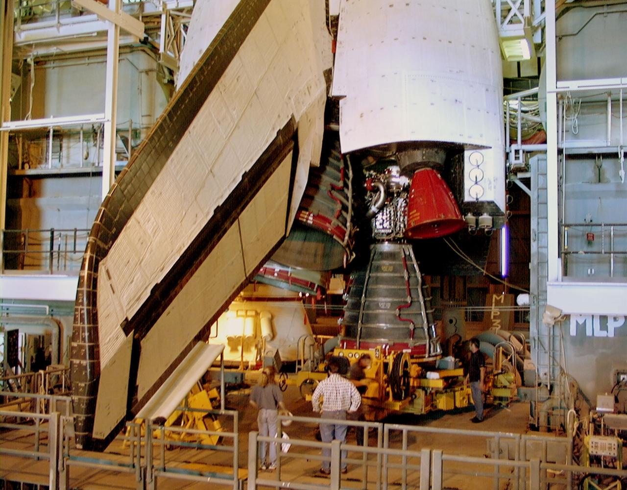 KENNEDY SPACE CENTER, FLA. -- Endeavour's replacement main engine No. 3 is moved underneath the orbiter for installation. Following routine testing procedures on a separate test engine, analysis revealed delamination on the wall of the engine's main combustion chamber. When data revealed that one of Endeavour's engines had undergone similar testing procedures, managers opted to replace the suspect engine as a precaution. Space Shuttle Endeavour is targeted for launch at 1:11 p.m. EST Jan. 13, 2000, on mission STS-99. It will be Endeavour's 14th flight. STS-99 is the Shuttle Radar Topography Mission
