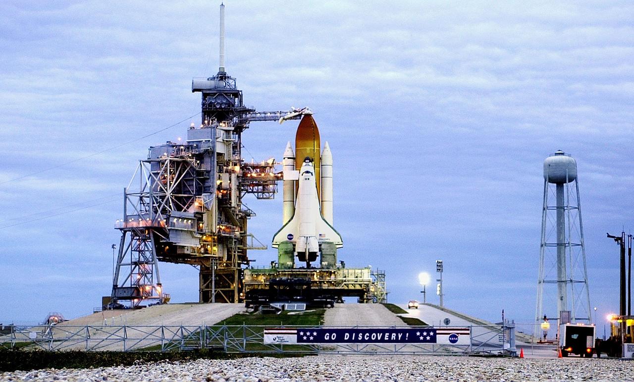 In the pre-dawn hours at Launch Pad 39B under a cloud-filled sky on the east coast of Florida, the Rotating Service Structure is rolled back to reveal the Space Shuttle Discovery poised for flight on mission STS-103. The rollback of the structure was complete at 4:46 a.m. EST. STS-103 is scheduled for launch Dec. 16 at 9:18 p.m. EST. The mission is expected to last about 9 days and 21 hours with a landing at KSC Sunday, Dec. 26, at 6:56 p.m. EST