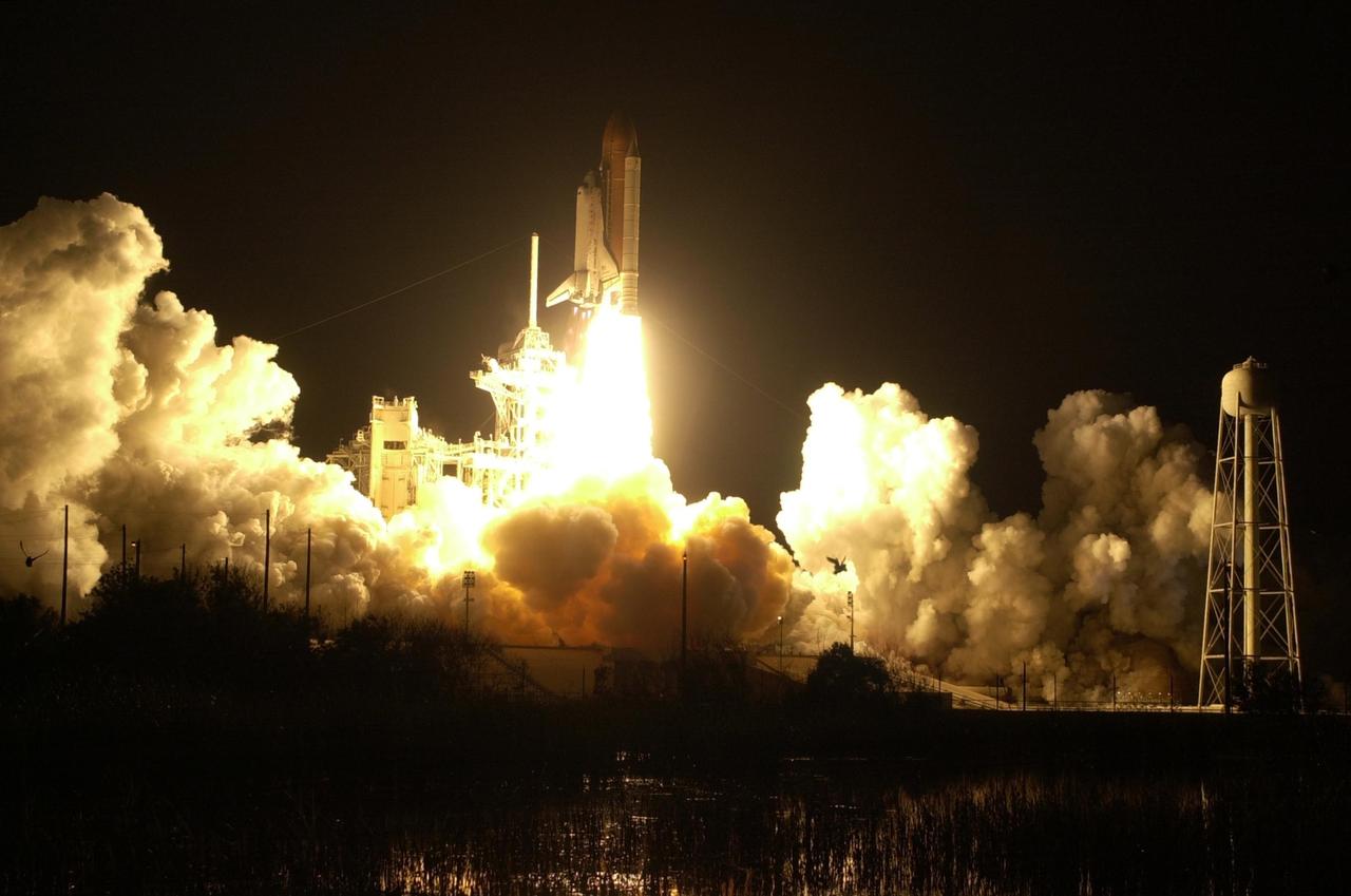 (Nikon camera D1 test)The blazing light of Space Shuttle Discovery's launch turns night into day at Launch Pad 39B as billows of smoke and steam rise behind it. The successful liftoff occurred on time at 7:50:00.069 EST from Launch Pad 39B on mission STS-103. On board are Commander Curtis L. Brown Jr., Pilot Scott J. Kelly and Mission Specialists Steven L. Smith, C. Michael Foale (Ph.D.), John M. Grunsfeld (Ph.D.), Claude Nicollier of Switzerland and Jean-François Clervoy of France. Nicollier and Clervoy are with the European Space Agency. STS-103 is a Hubble Servicing Mission, with three planned space walks designed to install new equipment and replace old. The primary objective is to replace the gyroscopes that make up the three Rate Sensor Units. Extravehicular activities include installing a new computer, changing out one of the Fine Guidance Sensors, replacing a tape recorder with a new solid state recorder, and installing a voltage/temperature improvement kit, and begin repairing the insulation on the telescope's outer surface. After the 7-day, 21-hour mission, Discovery is expected to land at KSC Monday, Dec. 27, at about 5:24 p.m. EST. This is the 27th flight of Discovery and the 96th mission in the Space Shuttle Program. It is the third launch at Kennedy Space Center in 1999