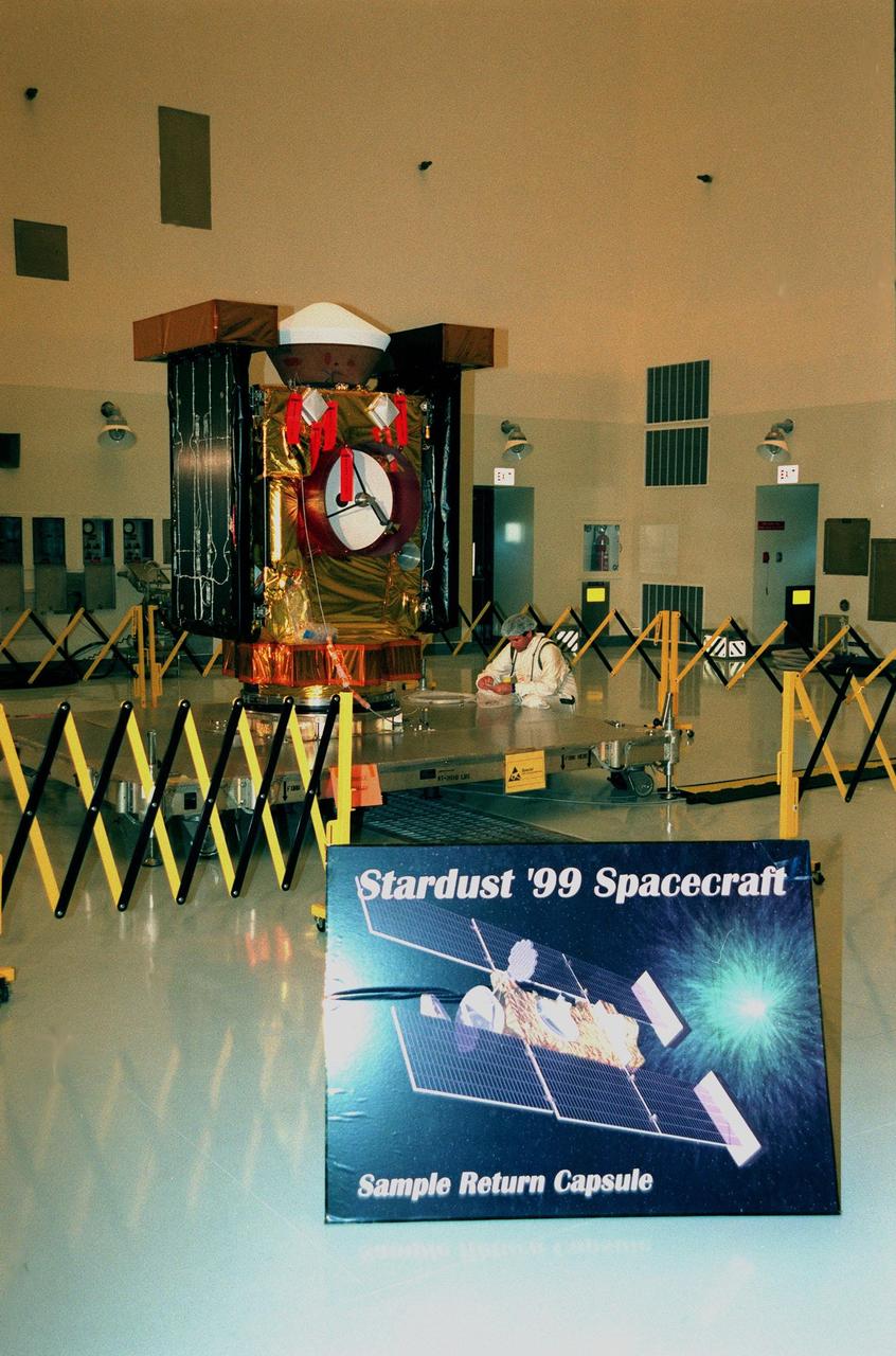 In the Payload Hazardous Servicing Facility, the spacecraft Stardust is on display for a media presentation. Stardust is targeted for launch on Feb. 6 aboard a Boeing Delta II rocket from Launch Pad 17-A, Cape Canaveral Air Station. The spacecraft is destined for a close encounter with the comet Wild 2 in January 2004. Using a silicon-based substance called aerogel, Stardust will capture comet particles flying off the nucleus of the comet. The spacecraft also will bring back samples of interstellar dust. These materials consist of ancient pre-solar interstellar grains and other remnants left over from the formation of the solar system. Scientists expect their analysis to provide important insights into the evolution of the sun and planets and possibly into the origin of life itself. The collected samples will return to Earth in a sample return capsule (the white-topped, blunt-nosed cone seen on the top of the spacecraft) to be jettisoned as Stardust swings by Earth in January 2006